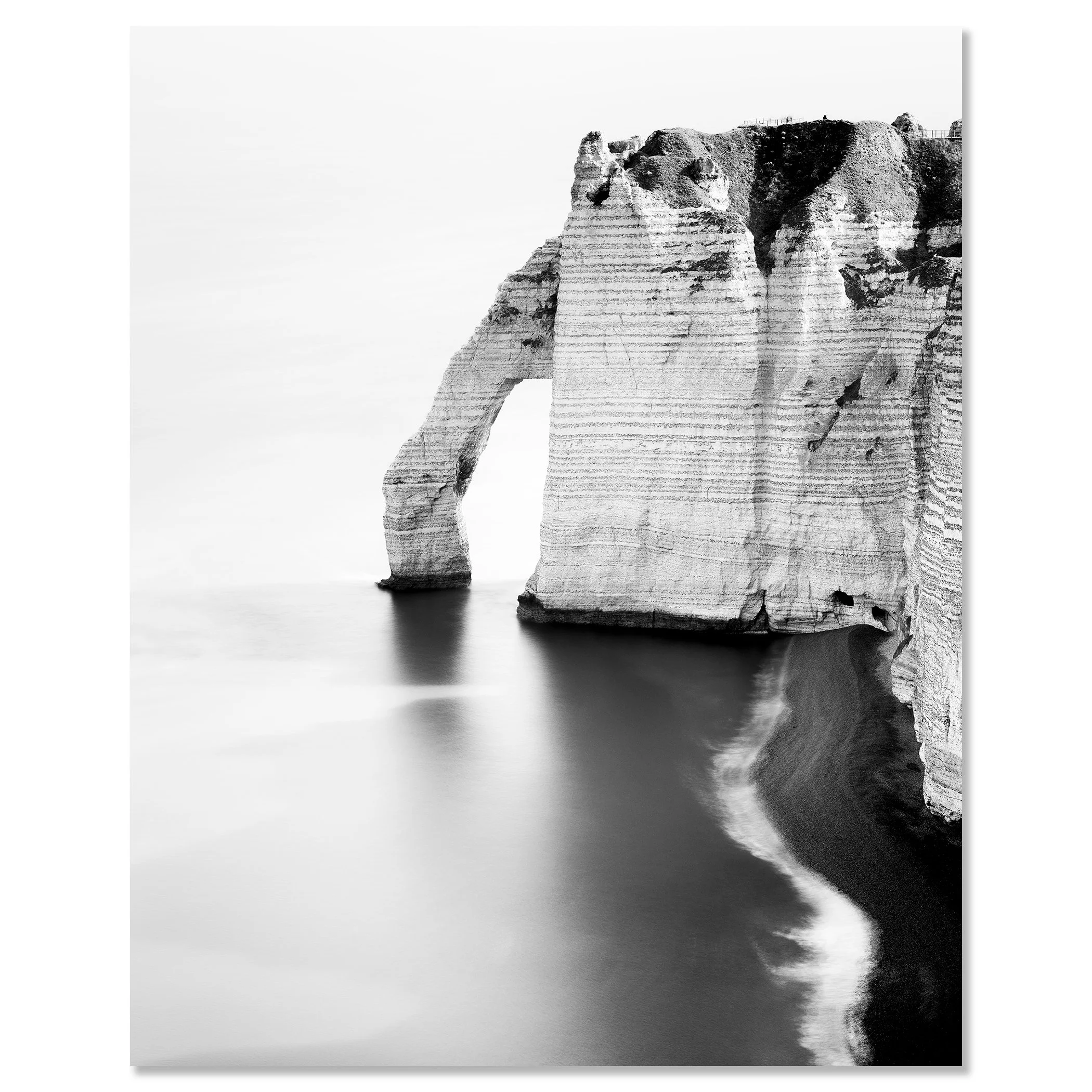 The Sea Arch at Étretat, France, frameless black-and-white photo print on Dibond. Photo by Gerald Berghammer.