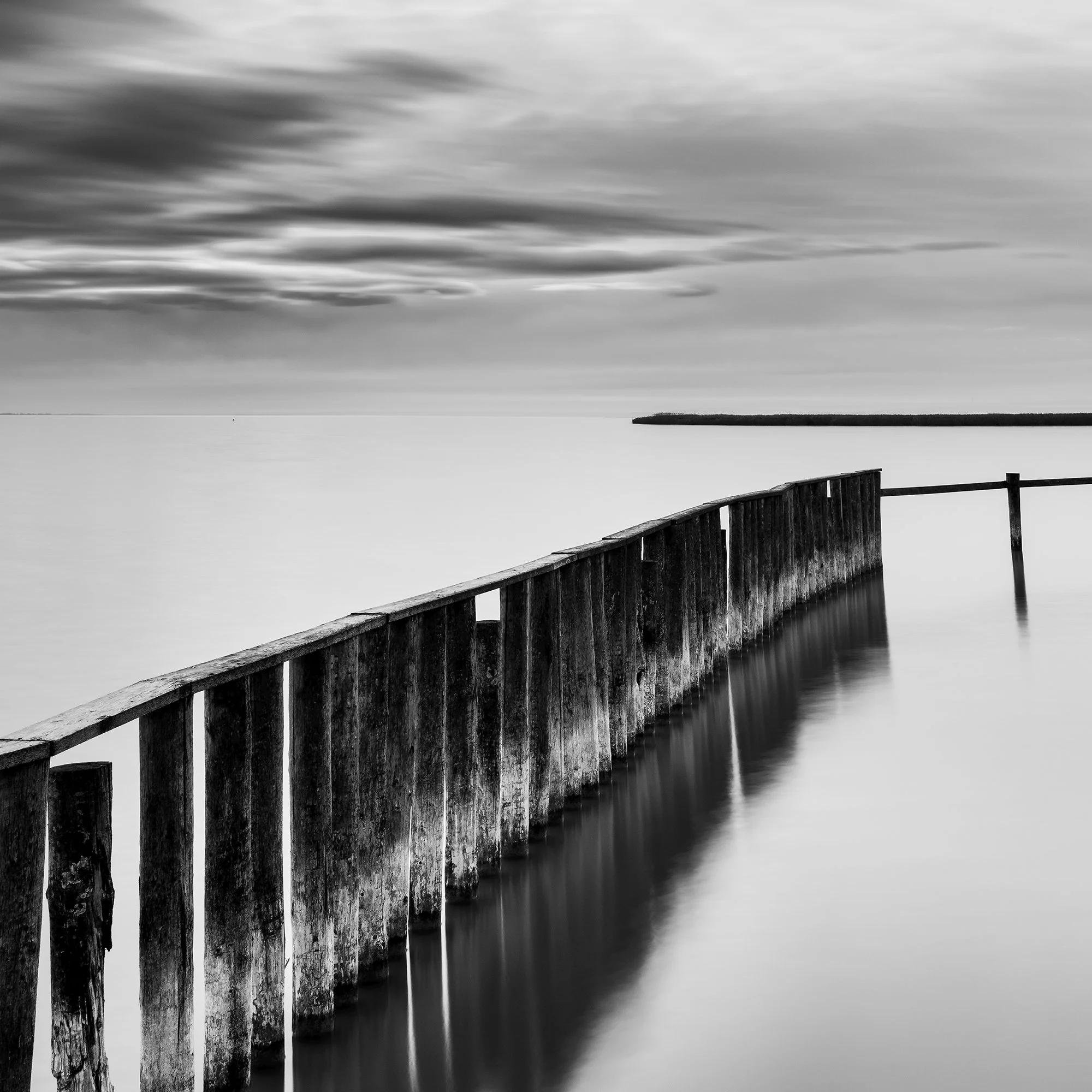 Detail of Swimming Area Study 3 showing the weathered wooden pier and smooth long-exposure water at Lake Neusiedl, Austria, by Gerald Berghammer.