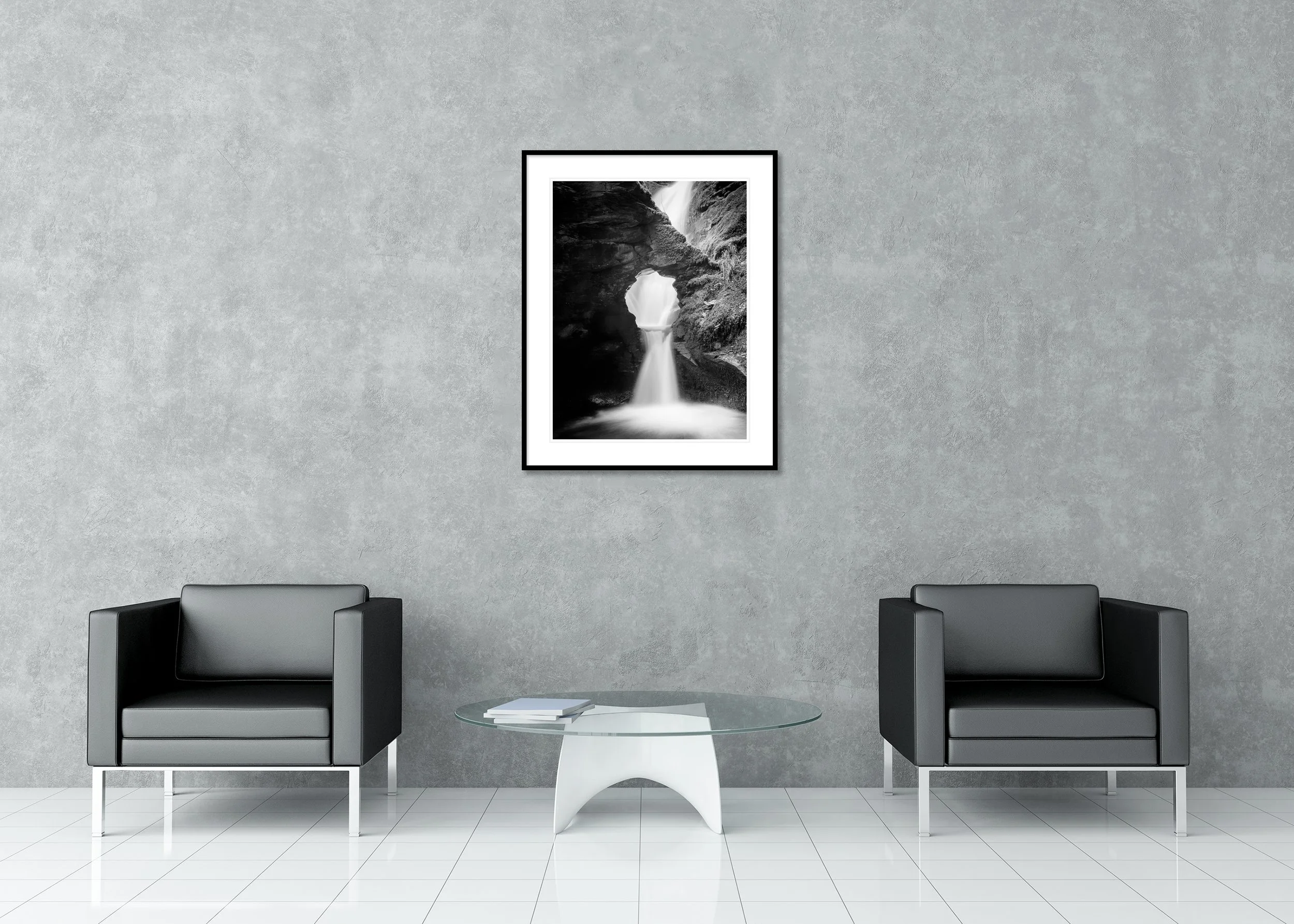 Long exposure black and white waterfall wall art with natural rock opening and soft flowing water, archival pigment print in a classic frame with mount