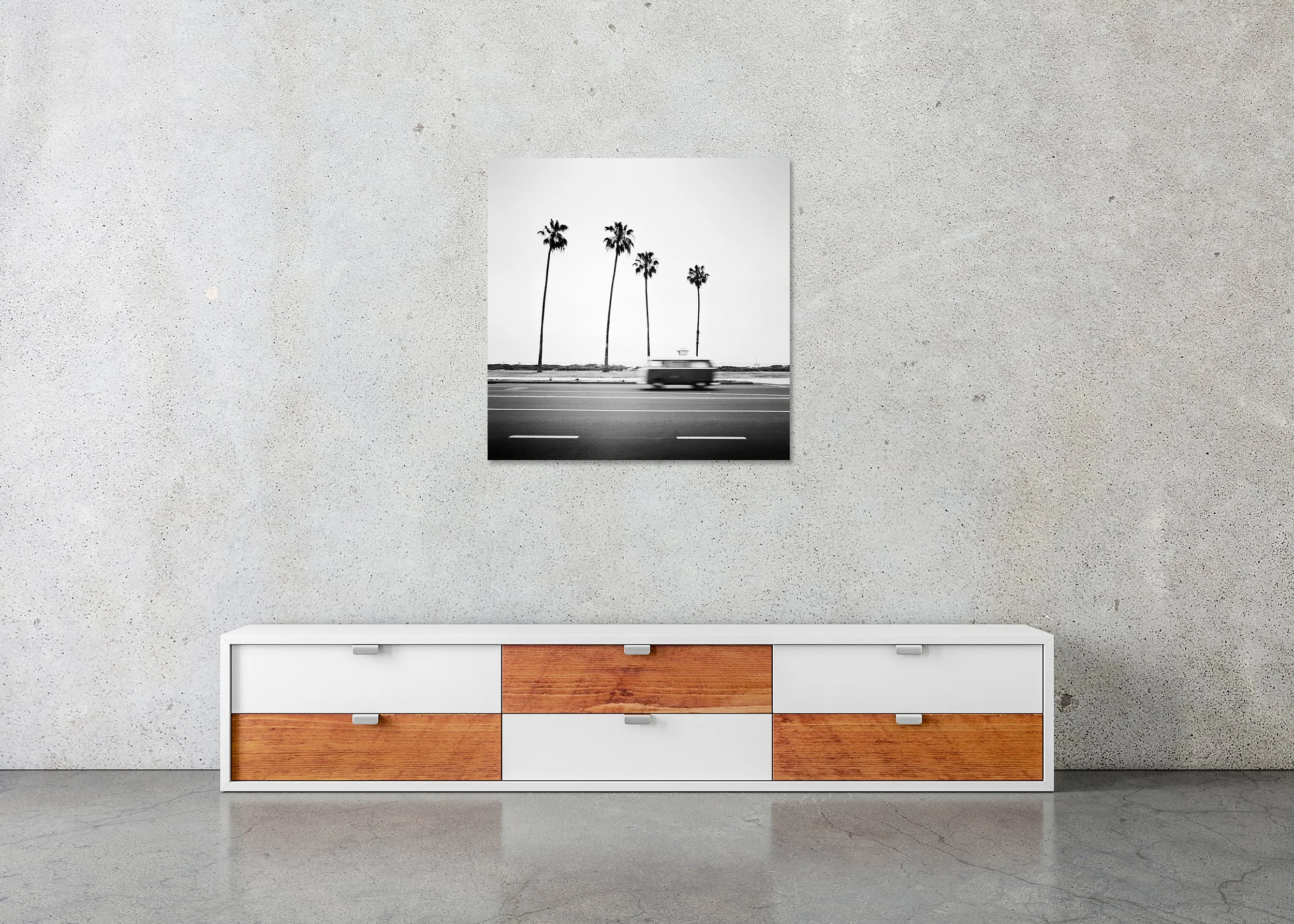 Black-and-white photo of a blurred vintage VW bus on a coastal road in Santa Barbara with tall palm trees, photo print mounted to Dibond, frameless.