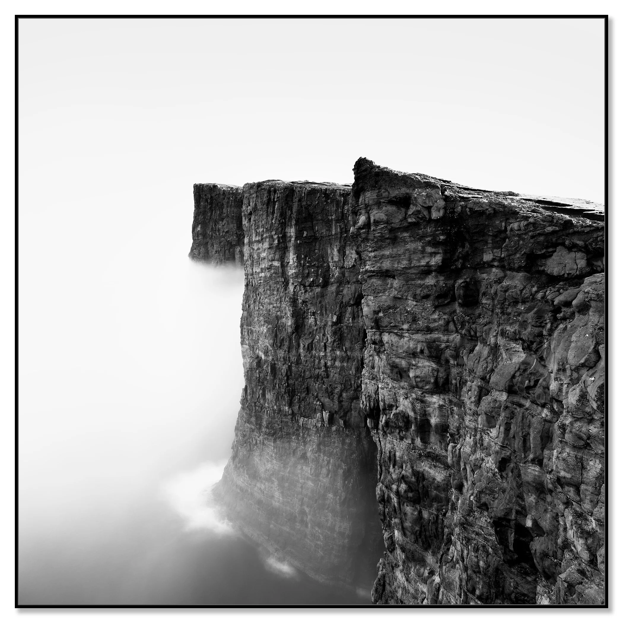 Minimalist black-and-white photo of rugged sea cliffs in mist over the North Atlantic, Faroe Islands – framed ArtBox black