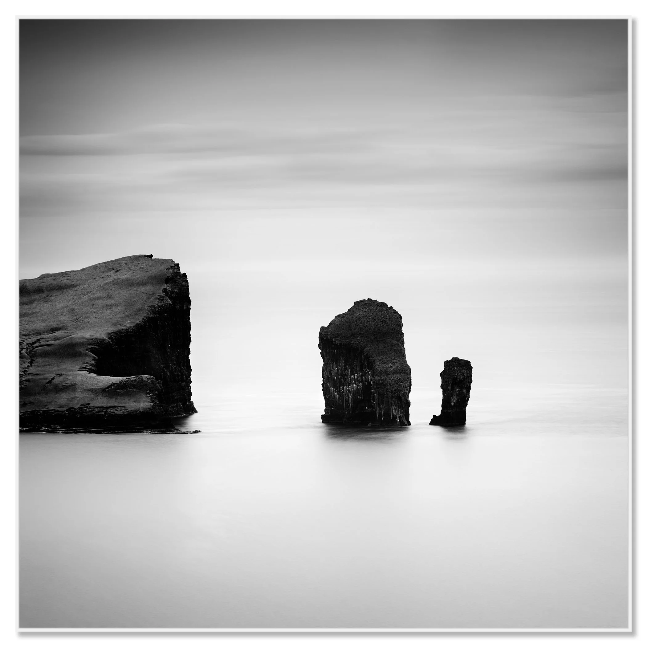 Black-and-white long exposure seascape with sea stacks off the coast of the Faroe Islands – framed ArtBox white