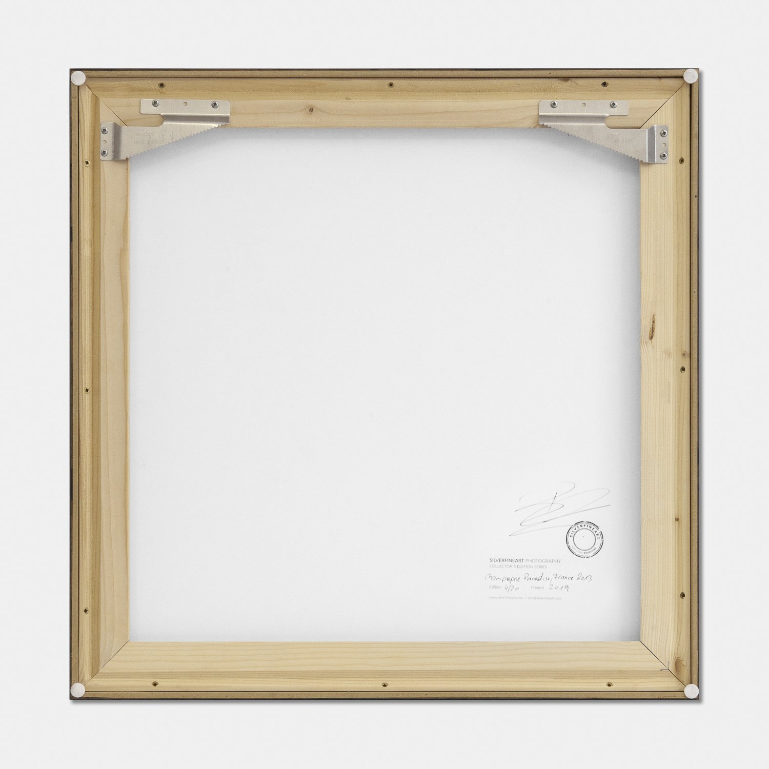 Reverse of Champagne Paradise by Gerald Berghammer, showing the wooden frame construction, artist's signature and edition stamp.