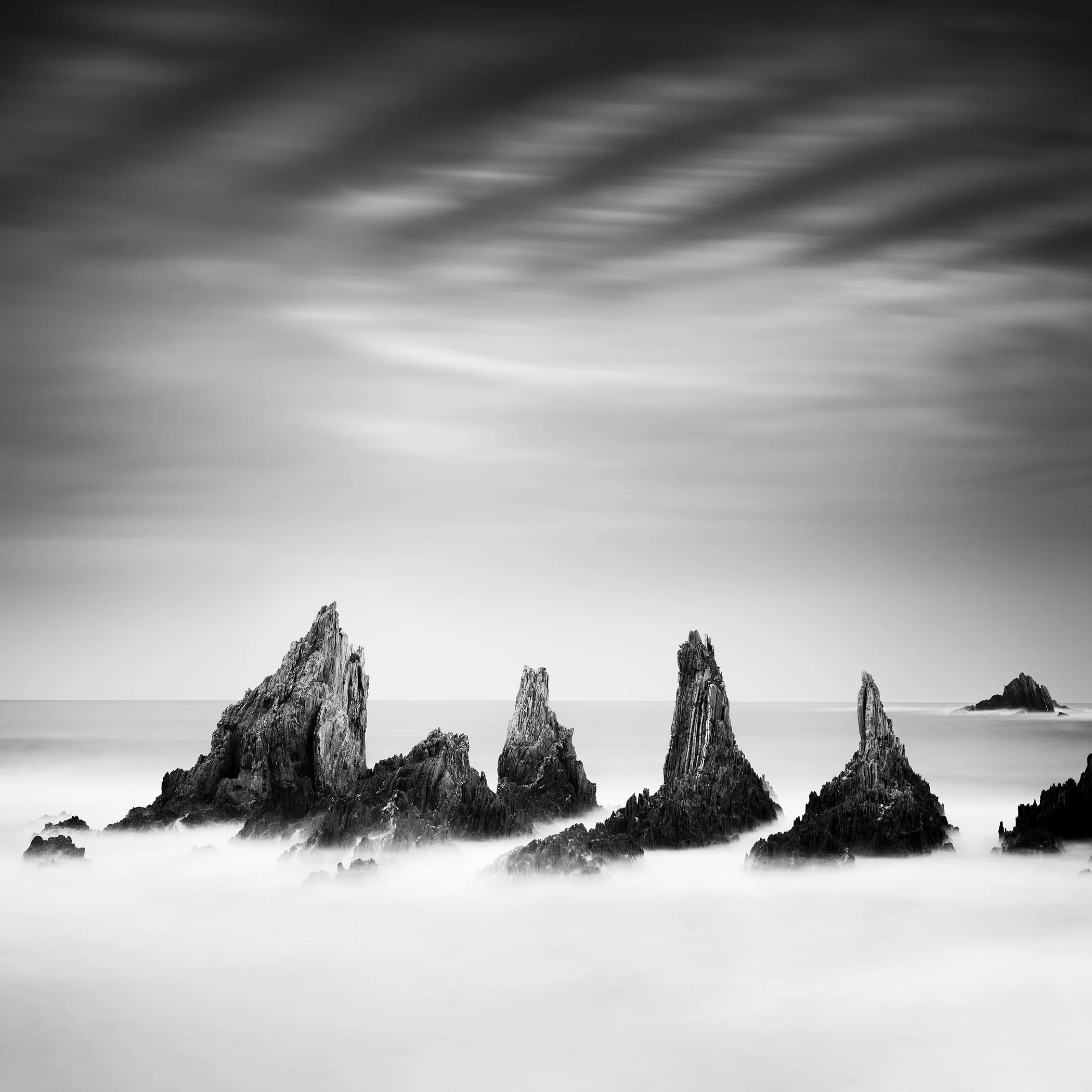 Rocky Peaks Study 4 – Spain by Gerald Berghammer, black-and-white coastal photograph with rocky peaks and dramatic clouds