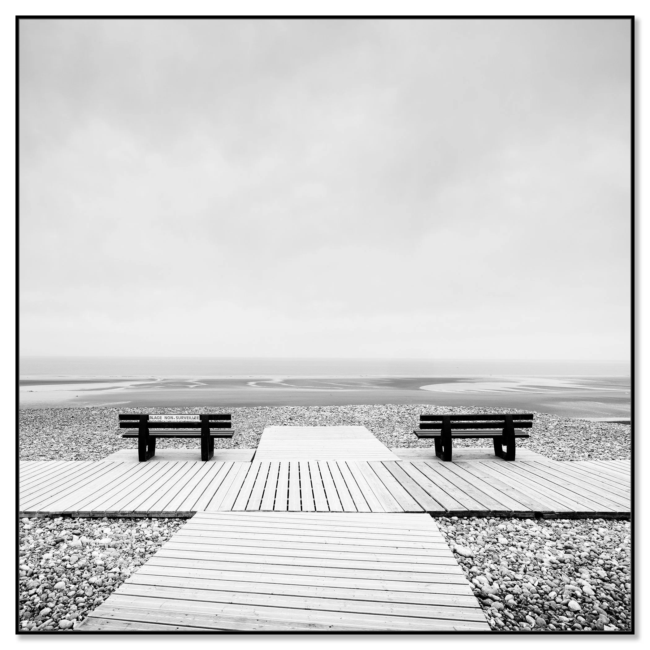Minimalist beach photograph from France featuring benches, a calm shoreline, open horizon and a clean, modern landscape composition – framed ArtBox black