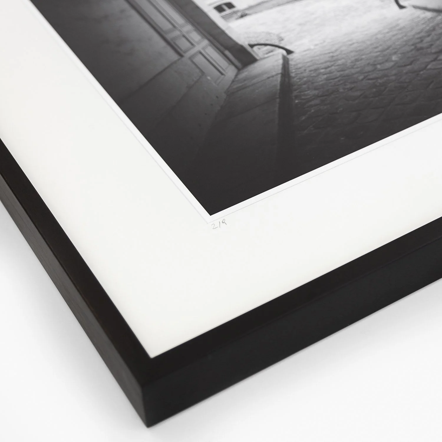 Gerald Berghammer – Tree in the Courtyard, angled detail of the framed print showing the white archival mount and black wooden frame.