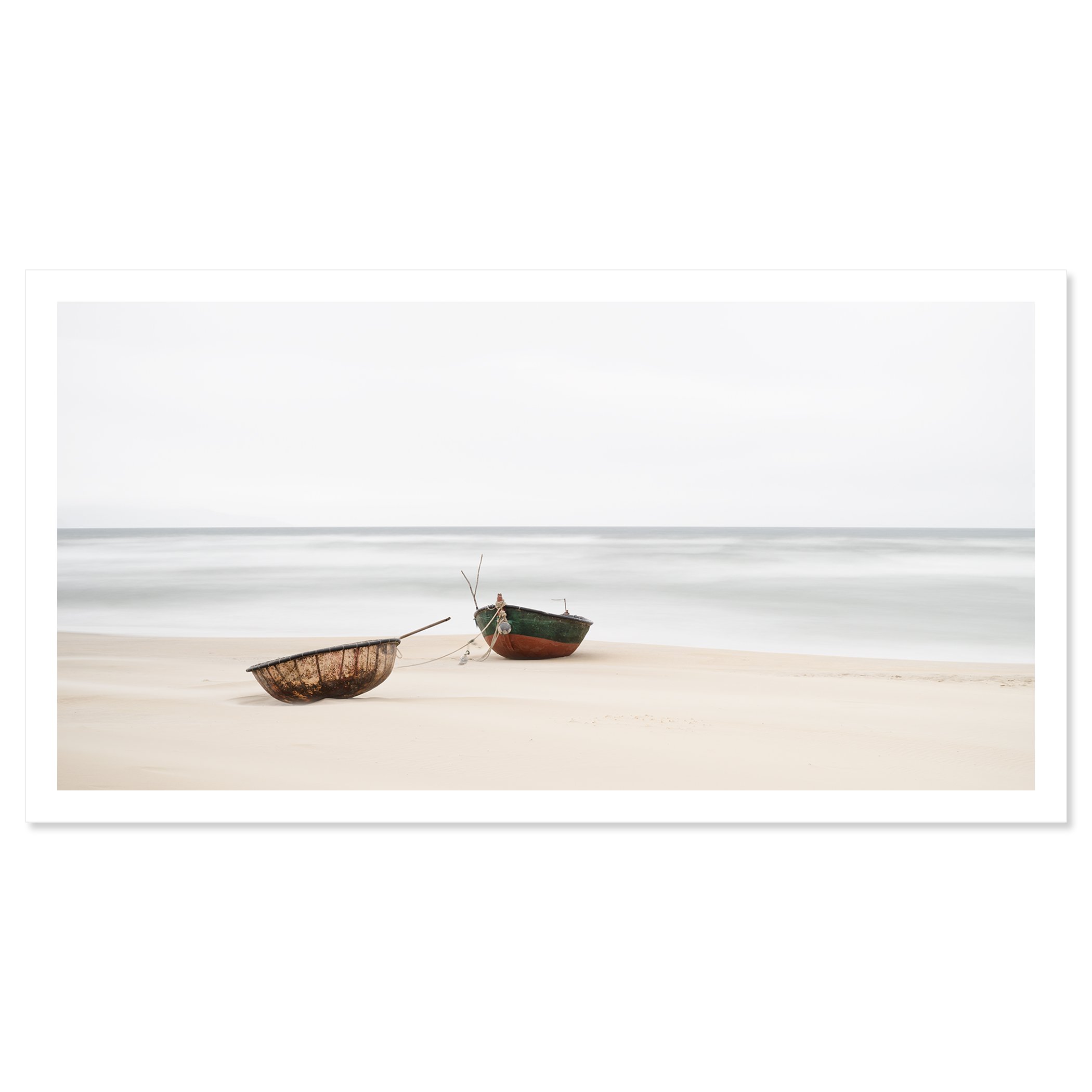 Gerald Berghammer - Color long exposure panorama photography. Two boats resting on a sandy beach near the ocean with calm waves and a cloudy sky. Fine art print only