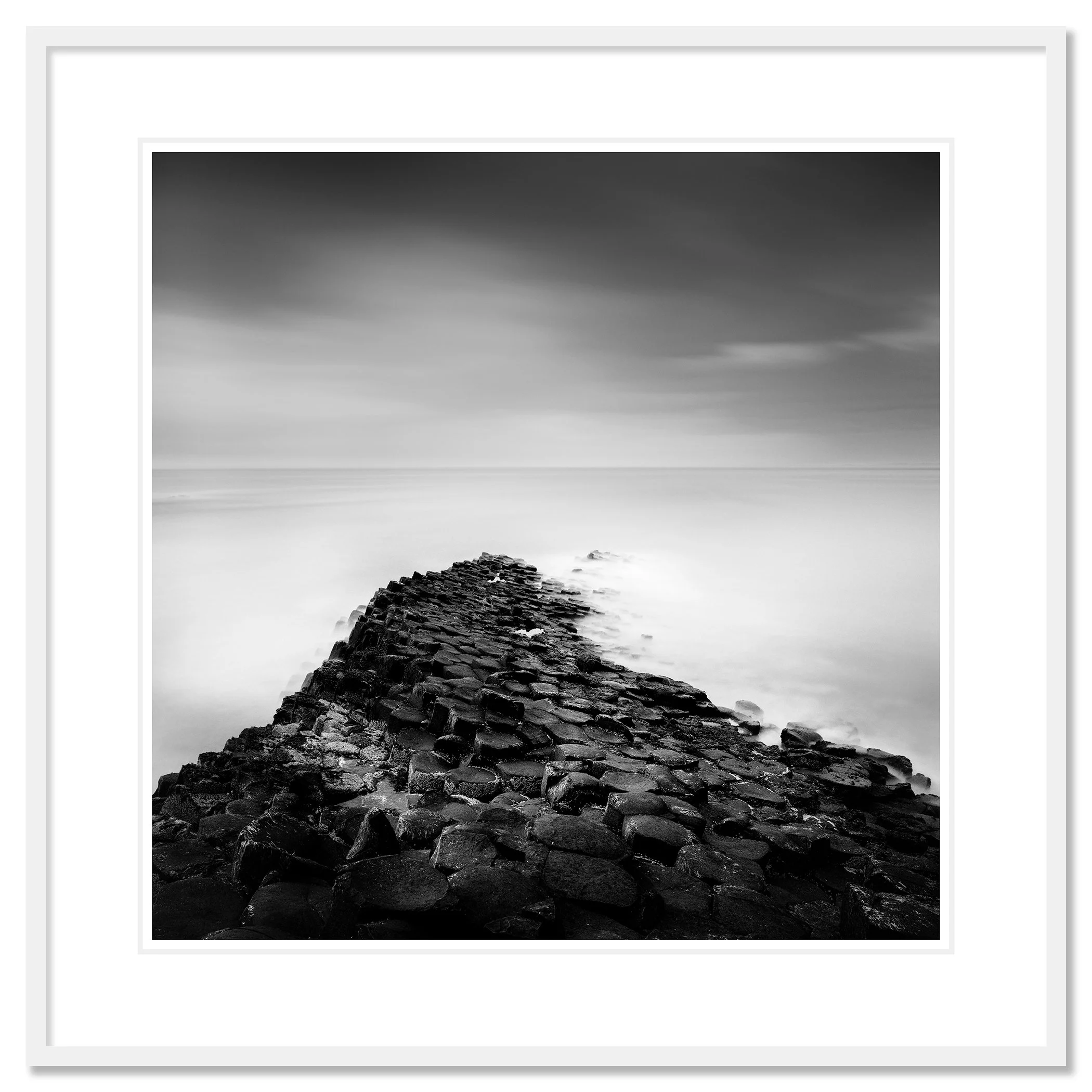 Giant’s Causeway Study 2 shown in a white aluminium frame with a white mount by Gerald Berghammer.