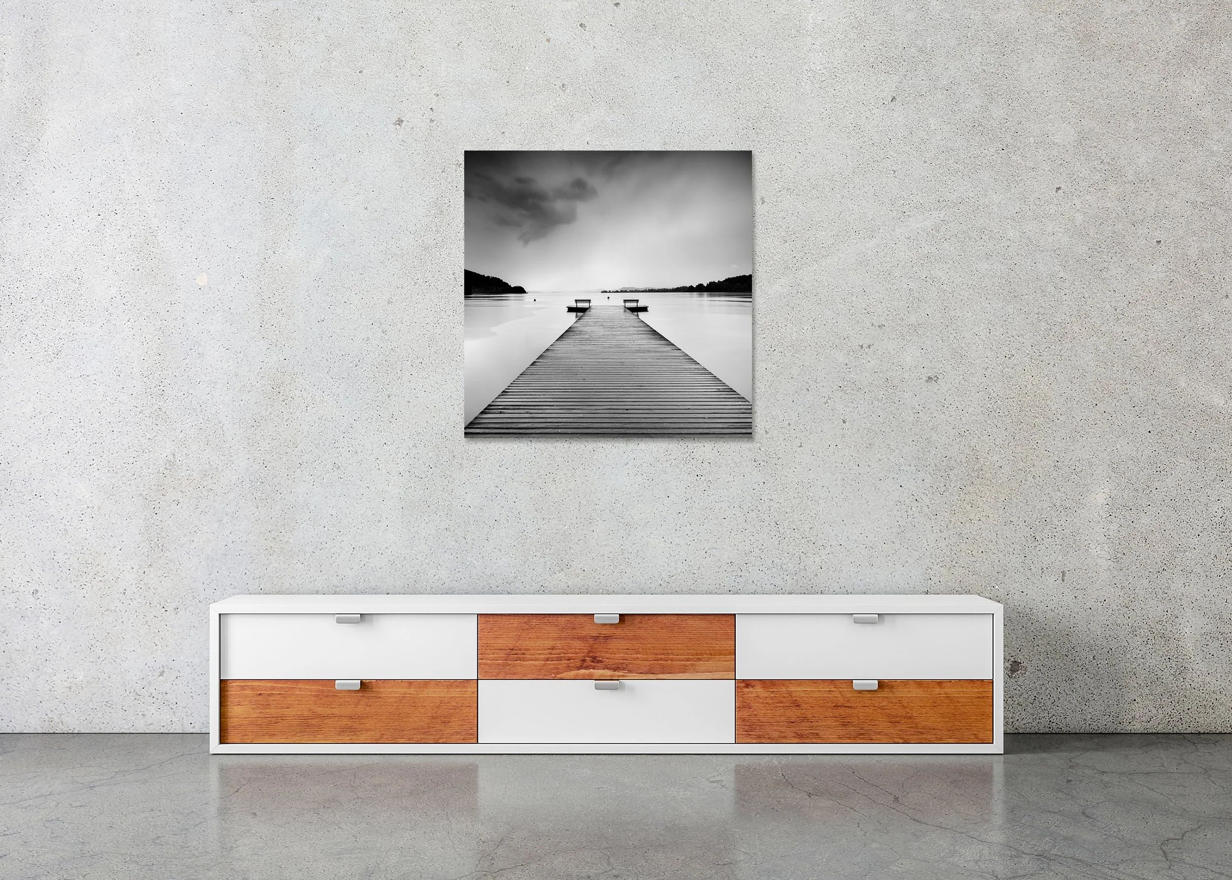 Lakeside Wooden Jetty, Study 1 – frameless black-and-white photo print on aluminium Dibond displayed above a low cabinet in a minimalist interior.
