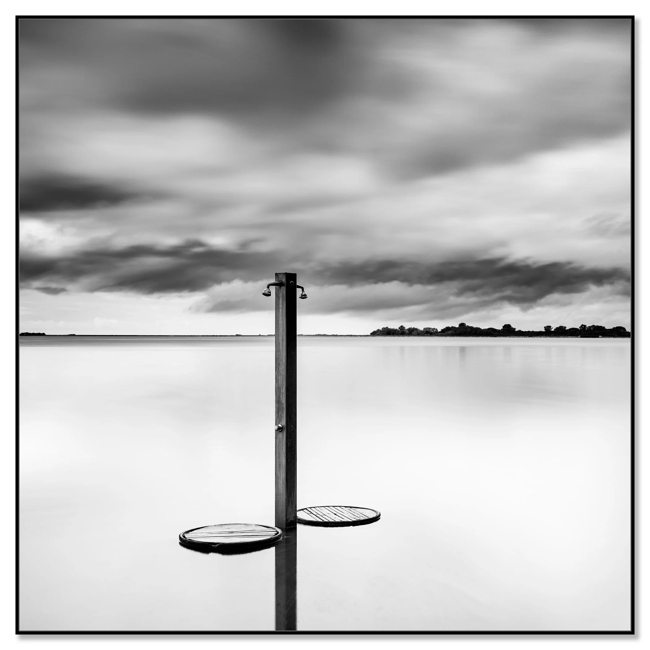 Beach Shower in a Storm – black-and-white fine art photograph mounted on aluminium Dibond in a black ArtBox frame by Gerald Berghammer.