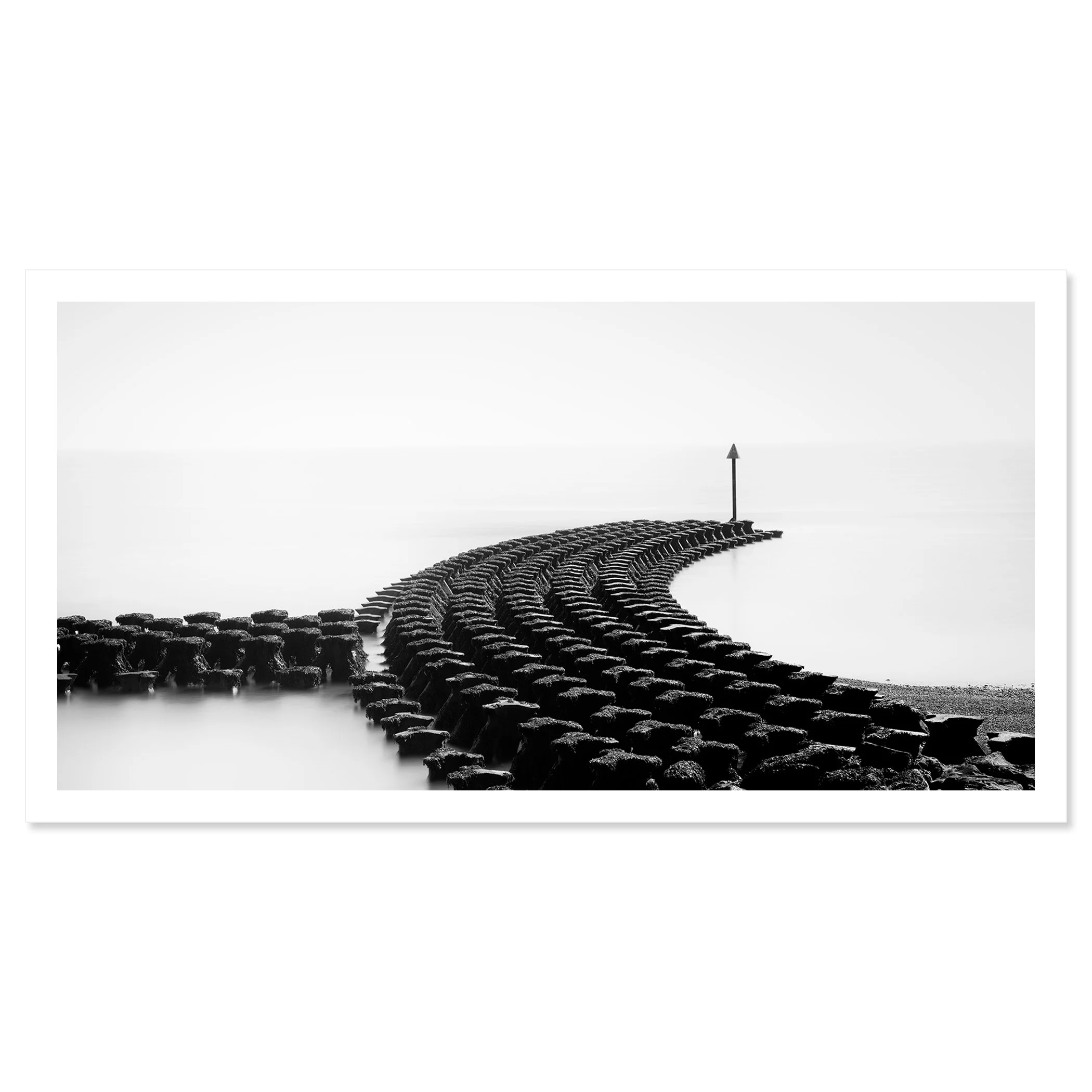 Gerald Berghammer - Black and white minimalist photography. A curved stone jetty extending into a calm body of water, with a tall navigation marker at the end. Fine art print only