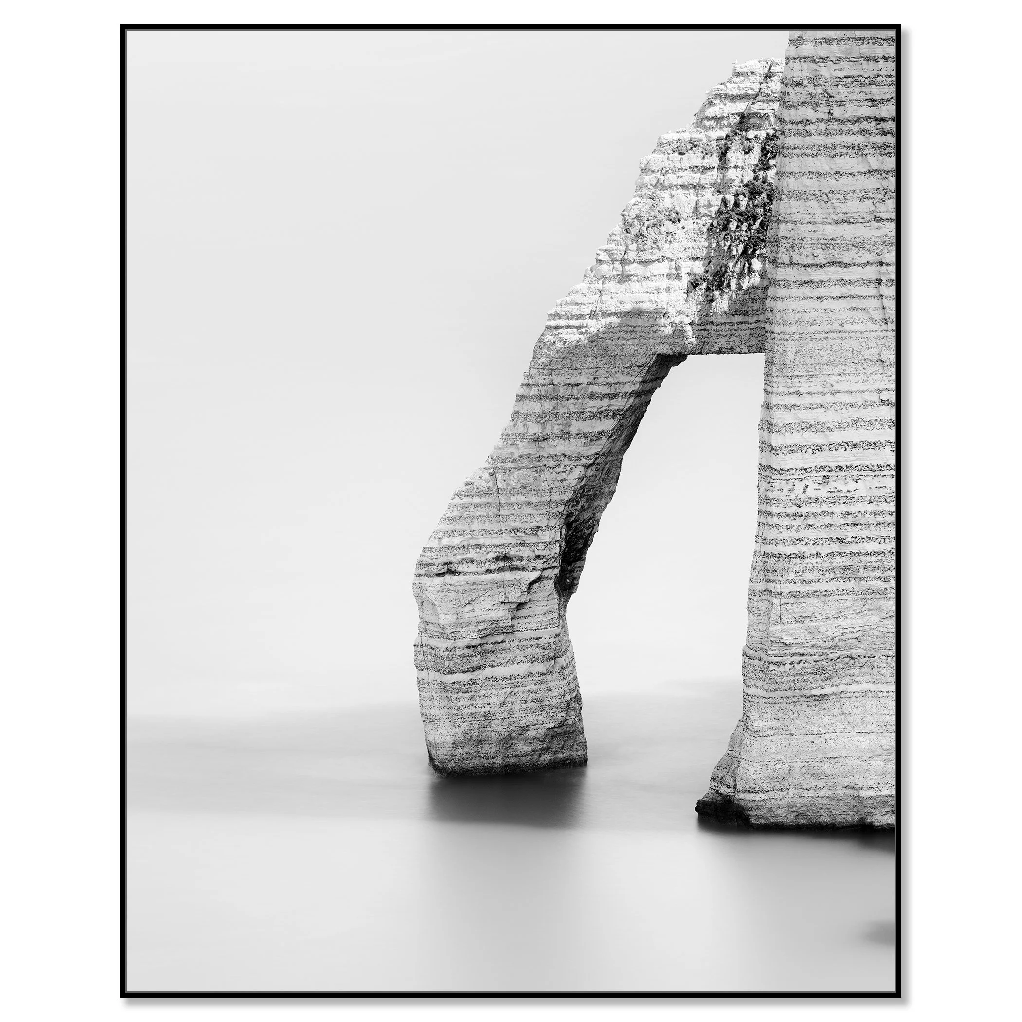Black and white photo of a minimalist stone arch sculpture with layered texture on a soft gray background – framed ArtBox black