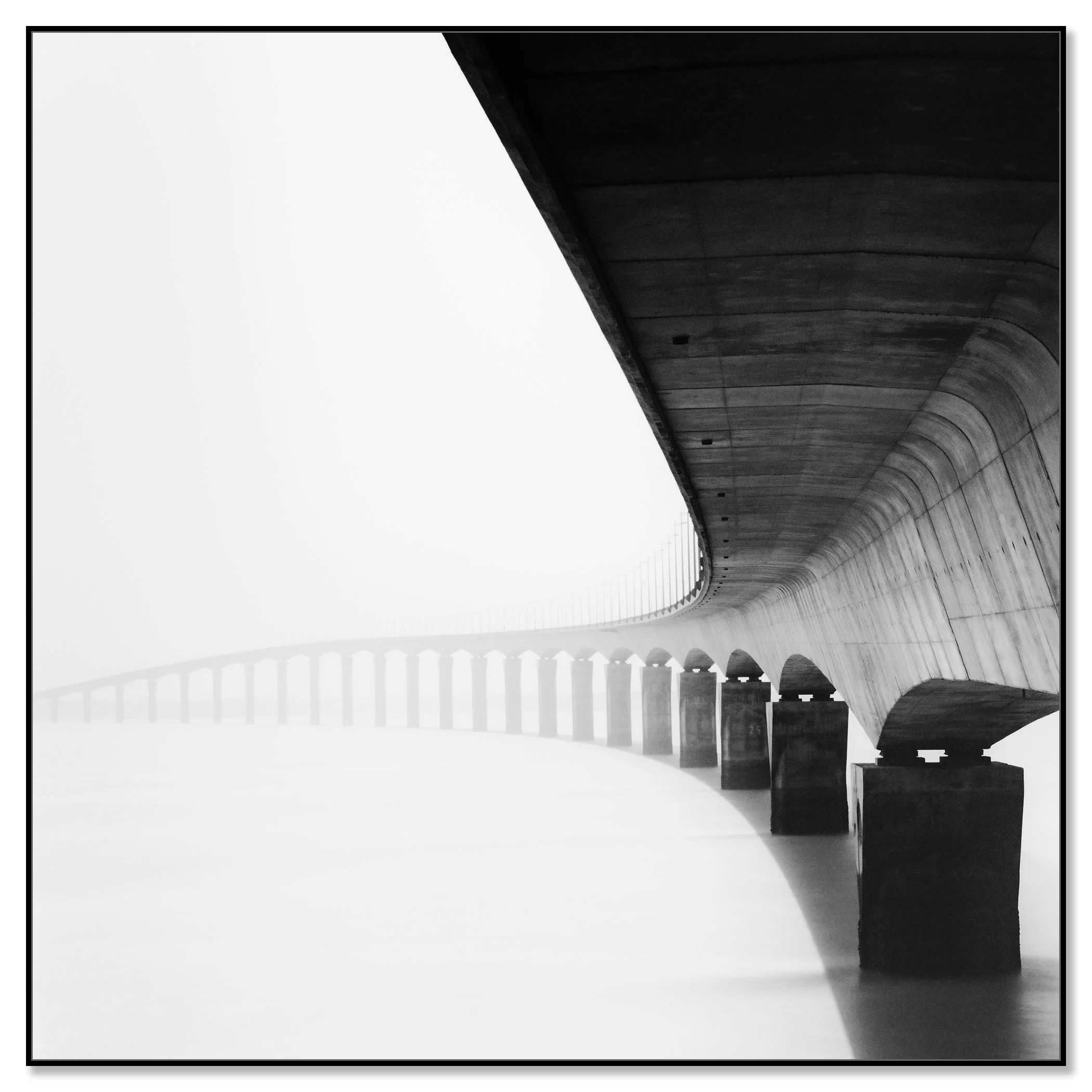 Île de Ré Bridge Study 1 – black-and-white photograph mounted on aluminium Dibond in a black aluminium ArtBox frame by Gerald Berghammer.