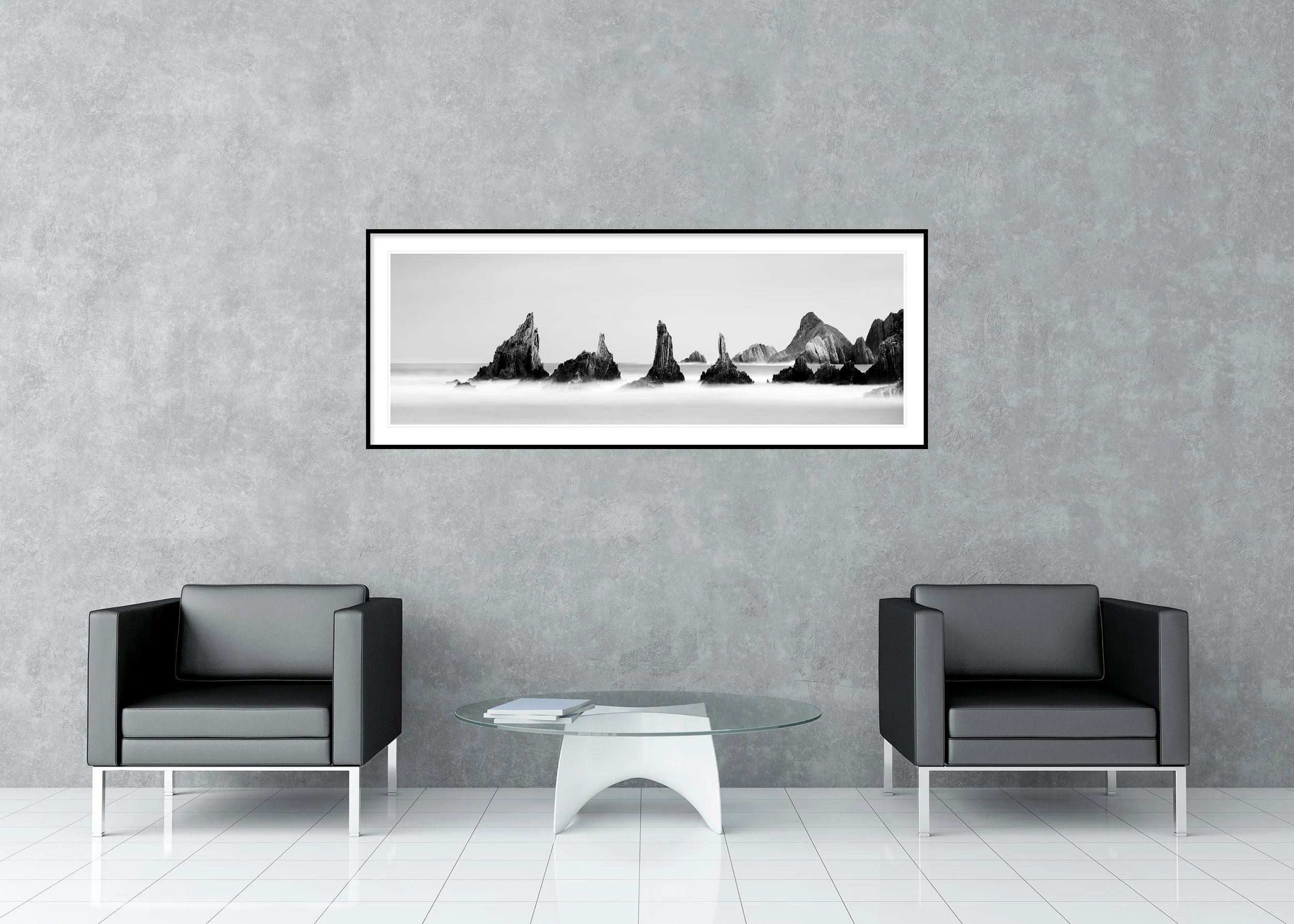 Black and white long-exposure seascape print with jagged sea stacks rising from a misty ocean, archival pigment print in a classic frame with mount.