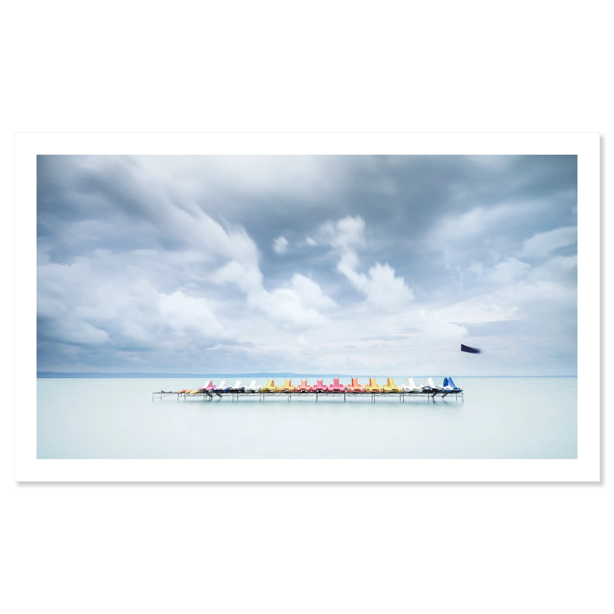 Gerald Berghammer - Color long exposure waterscape photography. Colorful paddle boats lined up on a dock over calm water, under a cloudy sky. Fine art print only