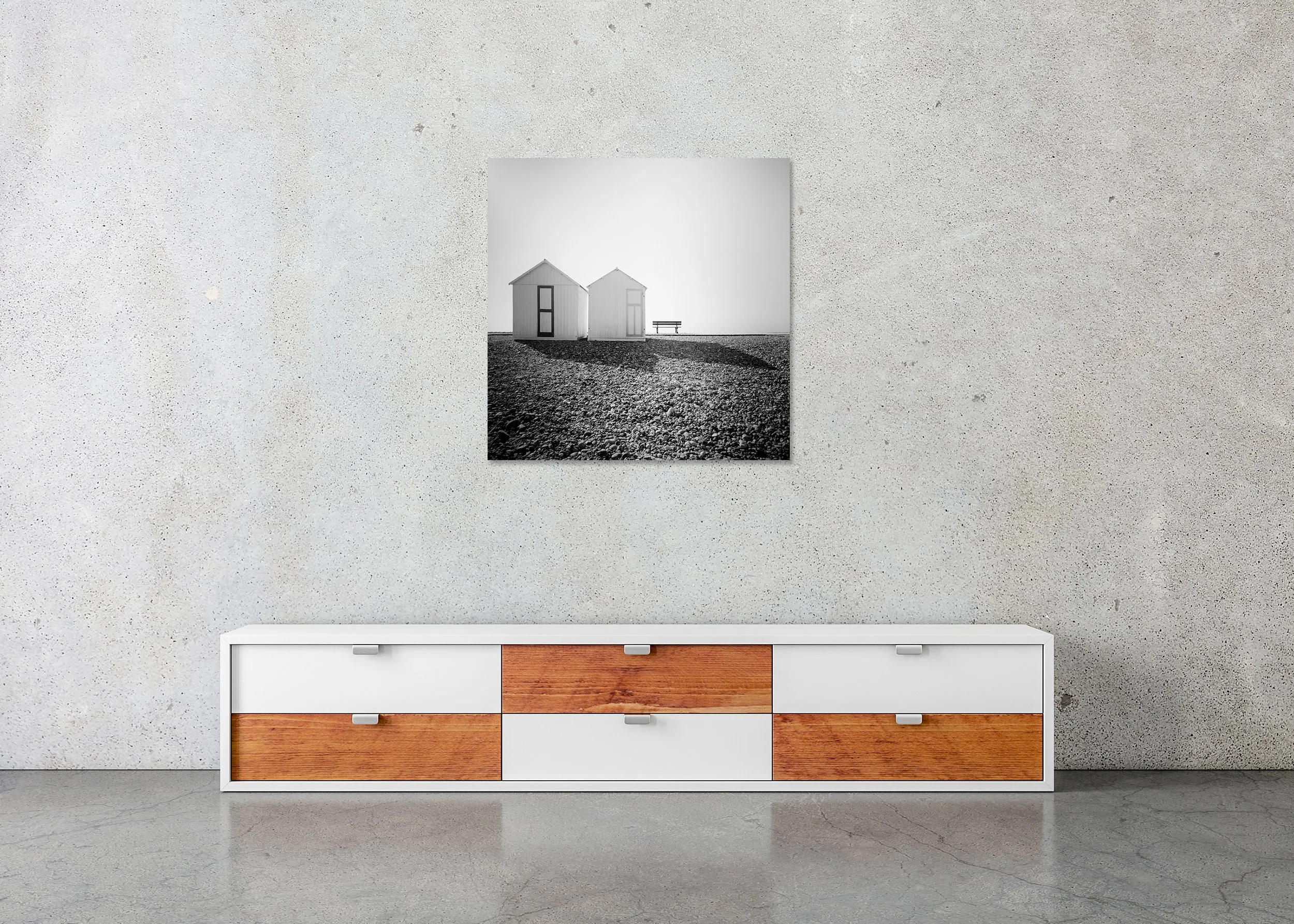 Beach Huts, Study 2 – France, frameless black-and-white photograph on aluminium Dibond displayed in a minimalist interior. Photo by Gerald Berghammer.