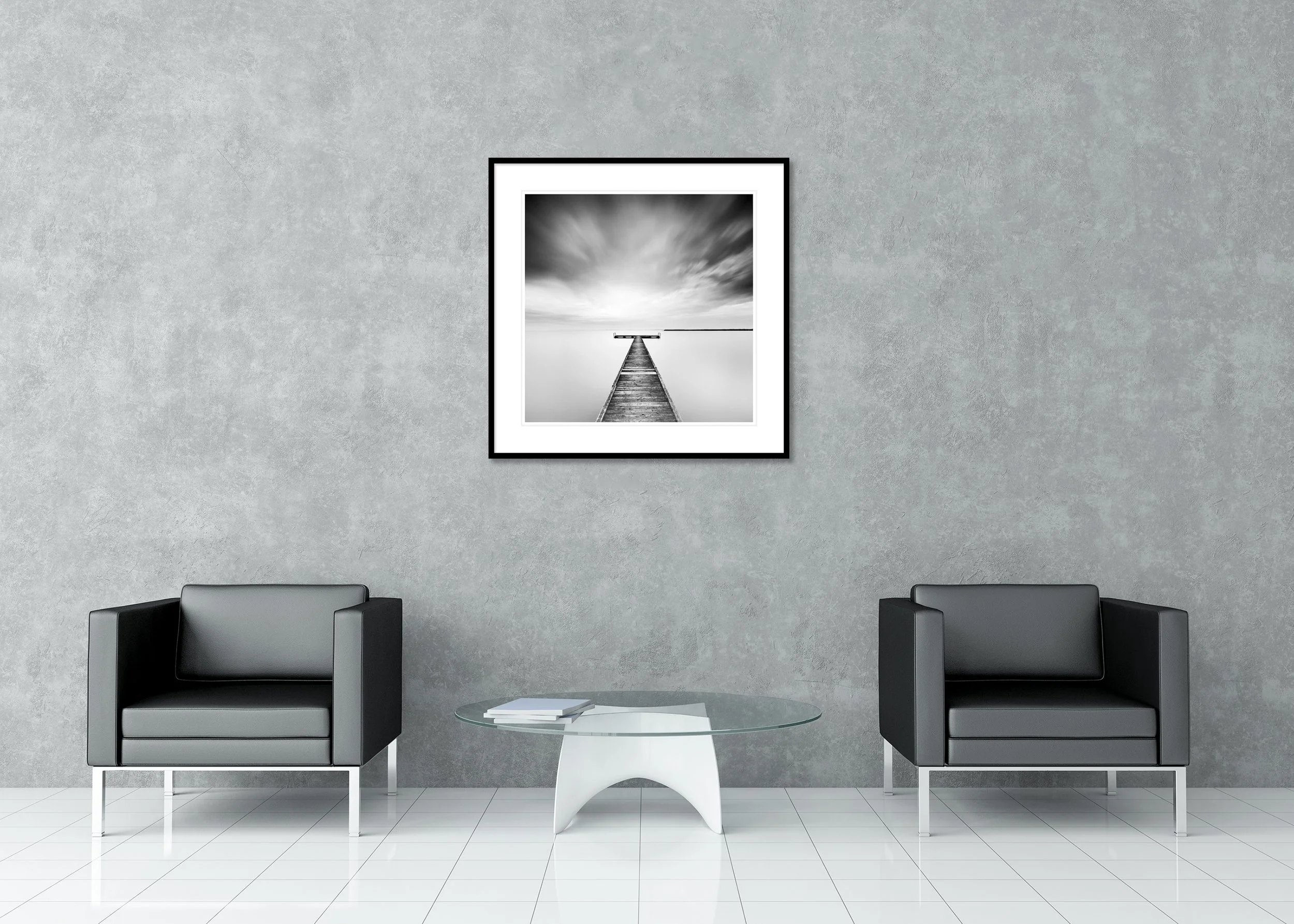 Monochrome long exposure photo of a wooden pier on a still lake beneath a moody sky, archival pigment print in a classic frame with mount