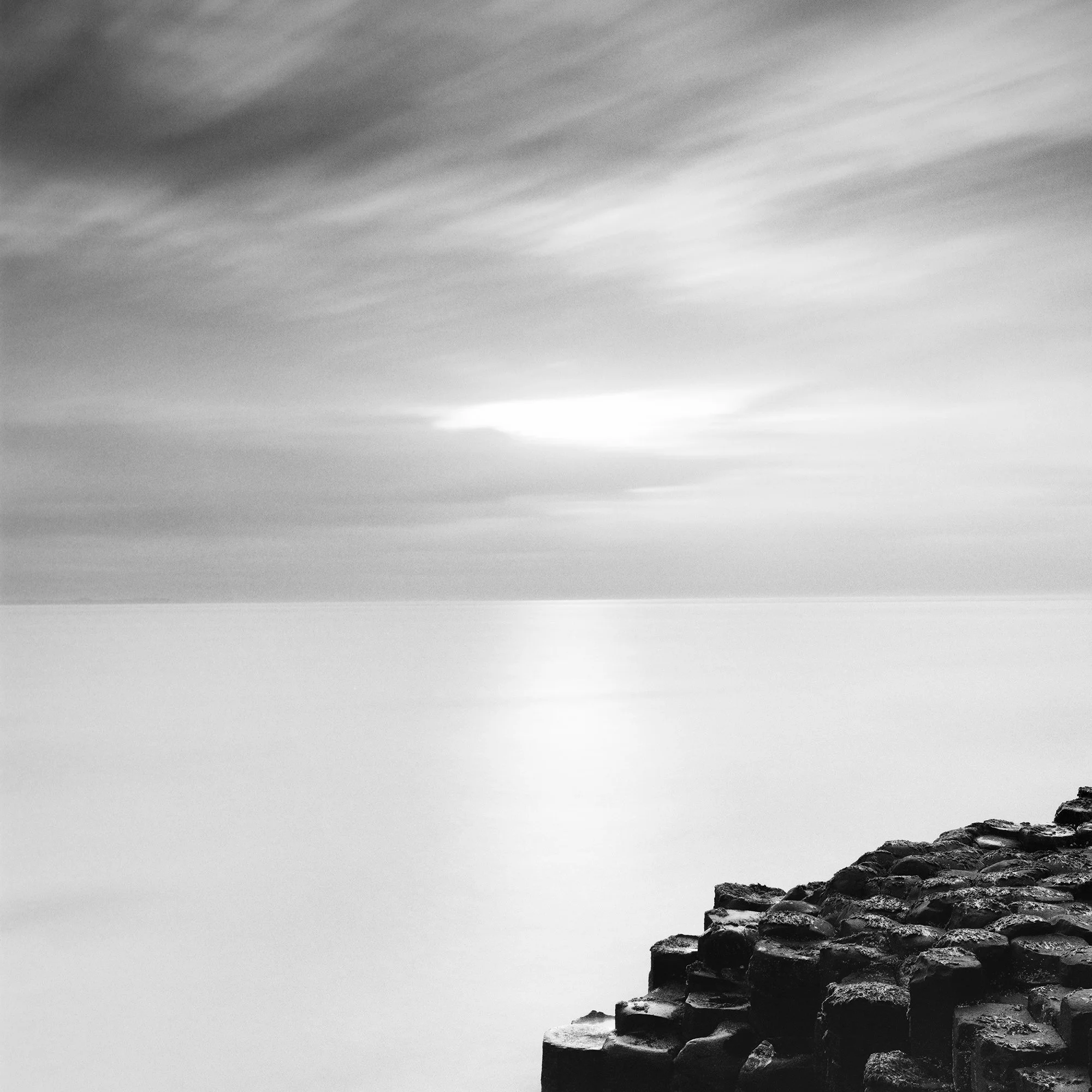 Giant’s Causeway Study 3 by Gerald Berghammer, close-up of the mist-like sea, dramatic sky and basalt rocks along the Northern Irish coast.