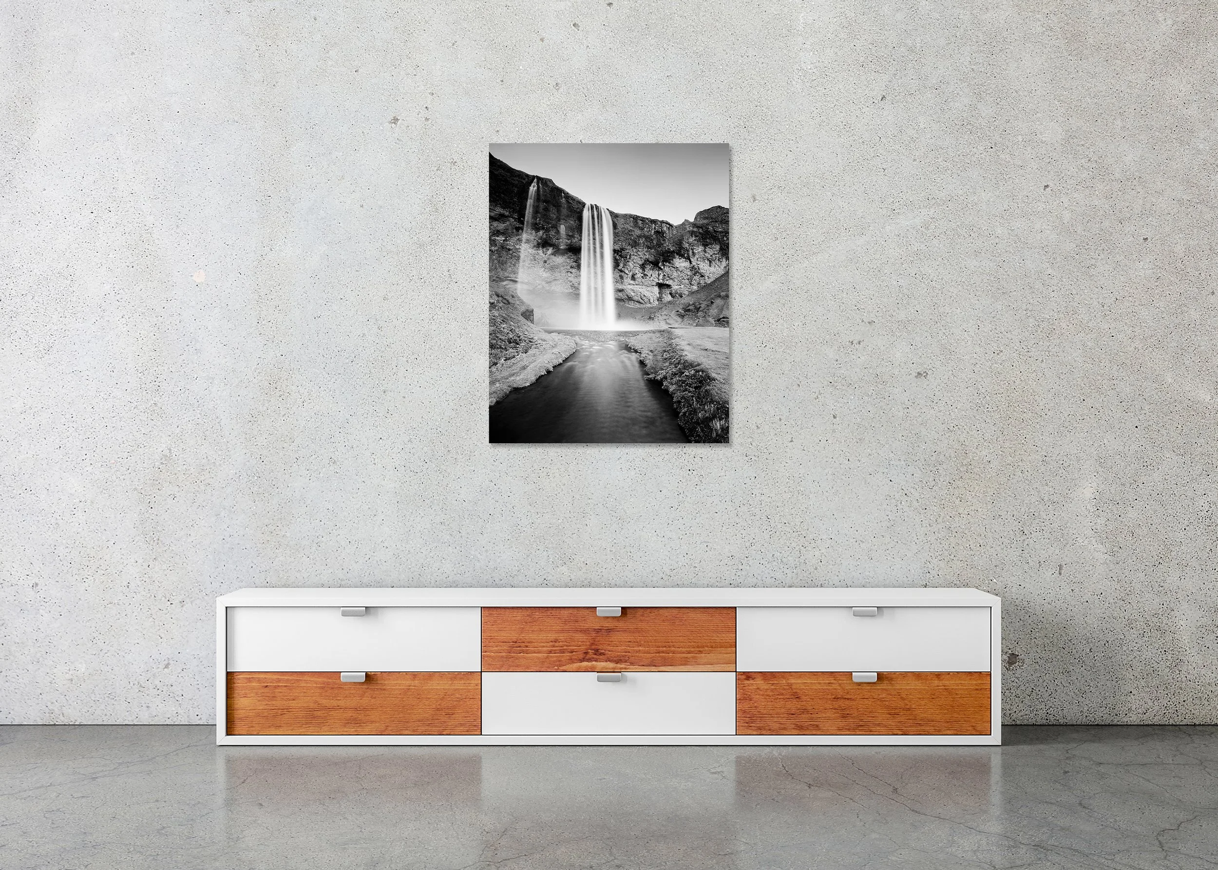 Seljalandsfoss Study 1 displayed in a modern interior as a frameless black-and-white artwork mounted on aluminium Dibond by Gerald Berghammer.