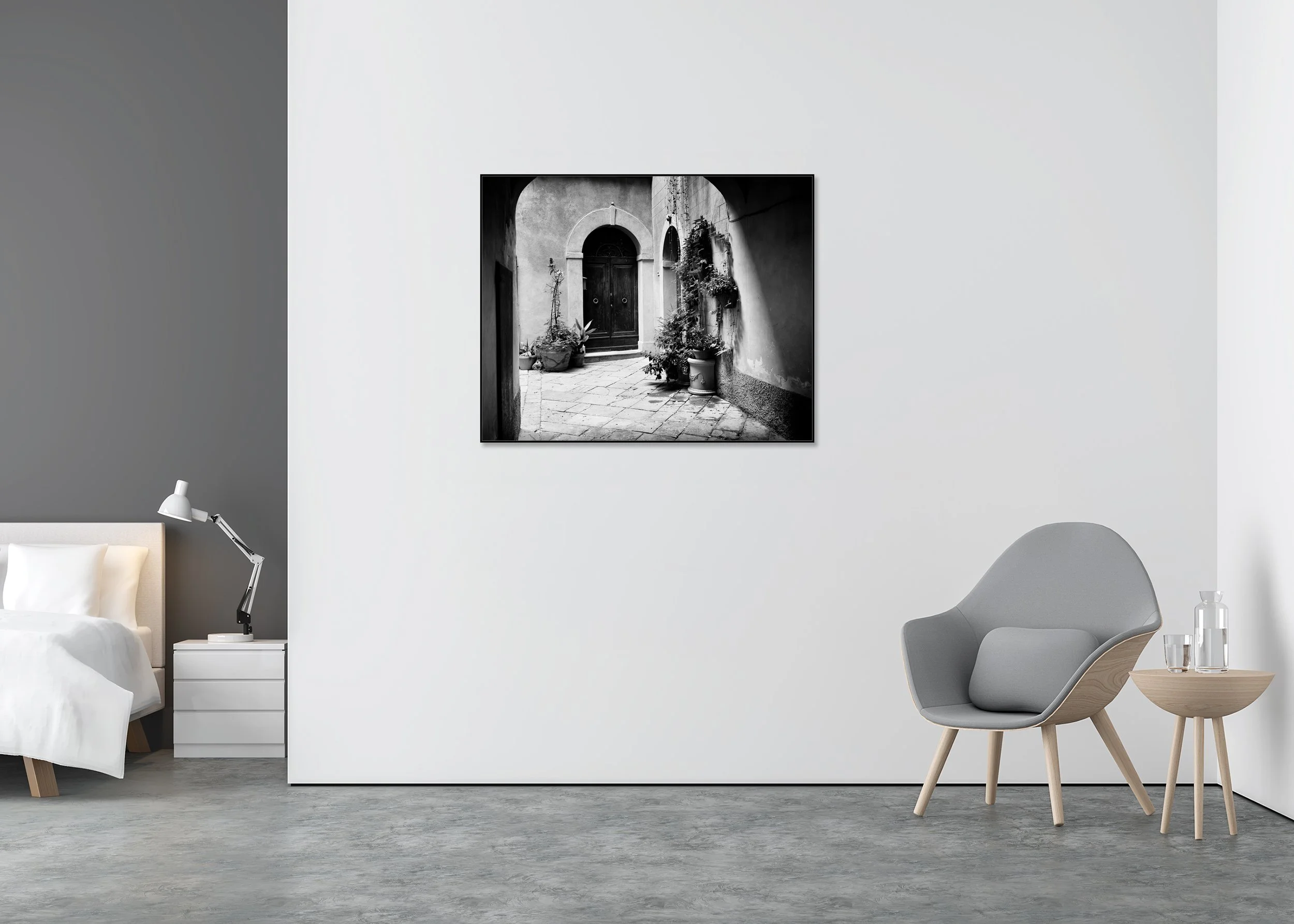 Tuscan Courtyard Study 2 displayed in a modern interior as a black-and-white Dibond print in a black aluminium ArtBox frame by Gerald Berghammer.
