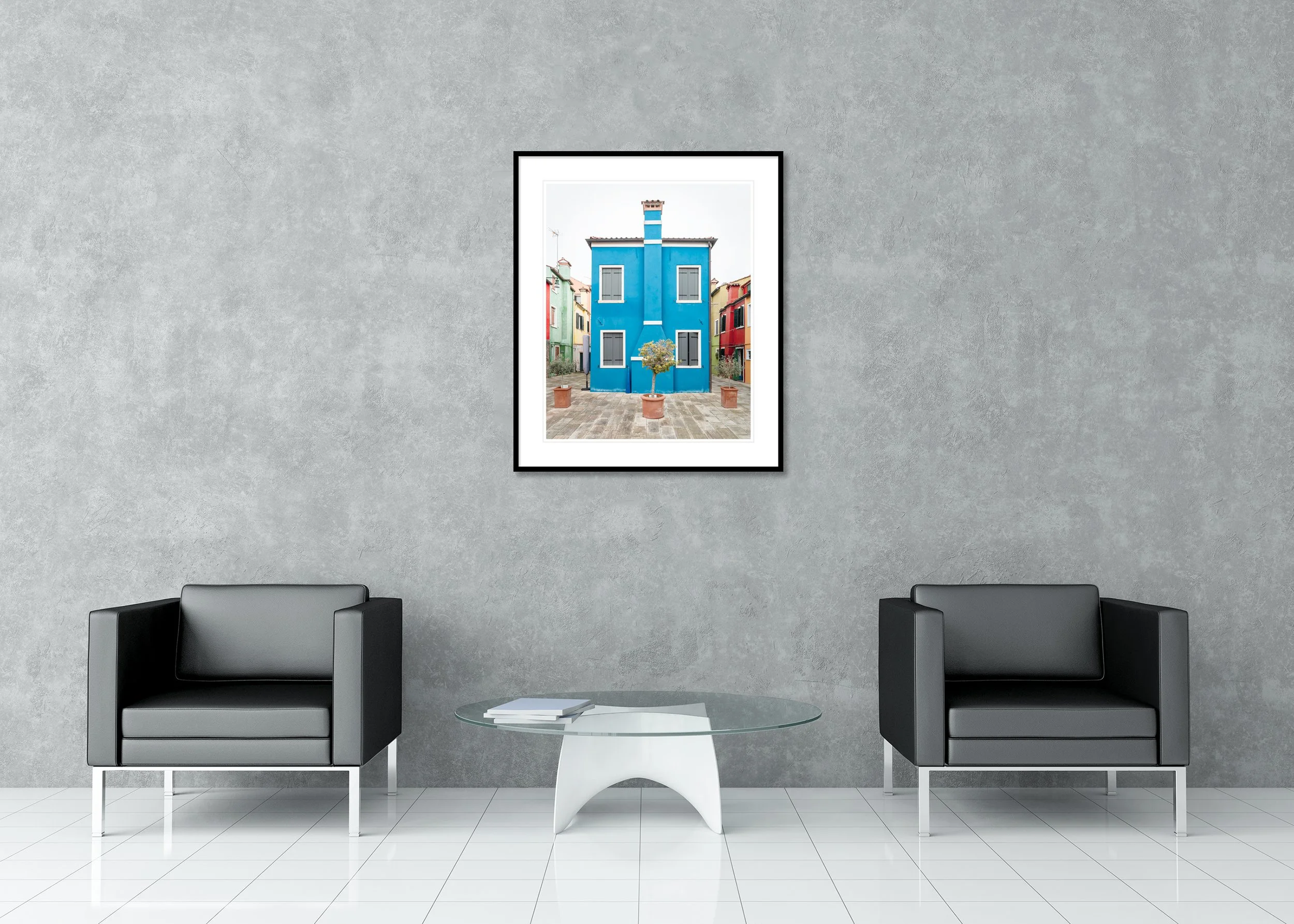 The Blue House displayed in a modern interior as an archival pigment print in a black aluminium frame with a white mount by Gerald Berghammer.