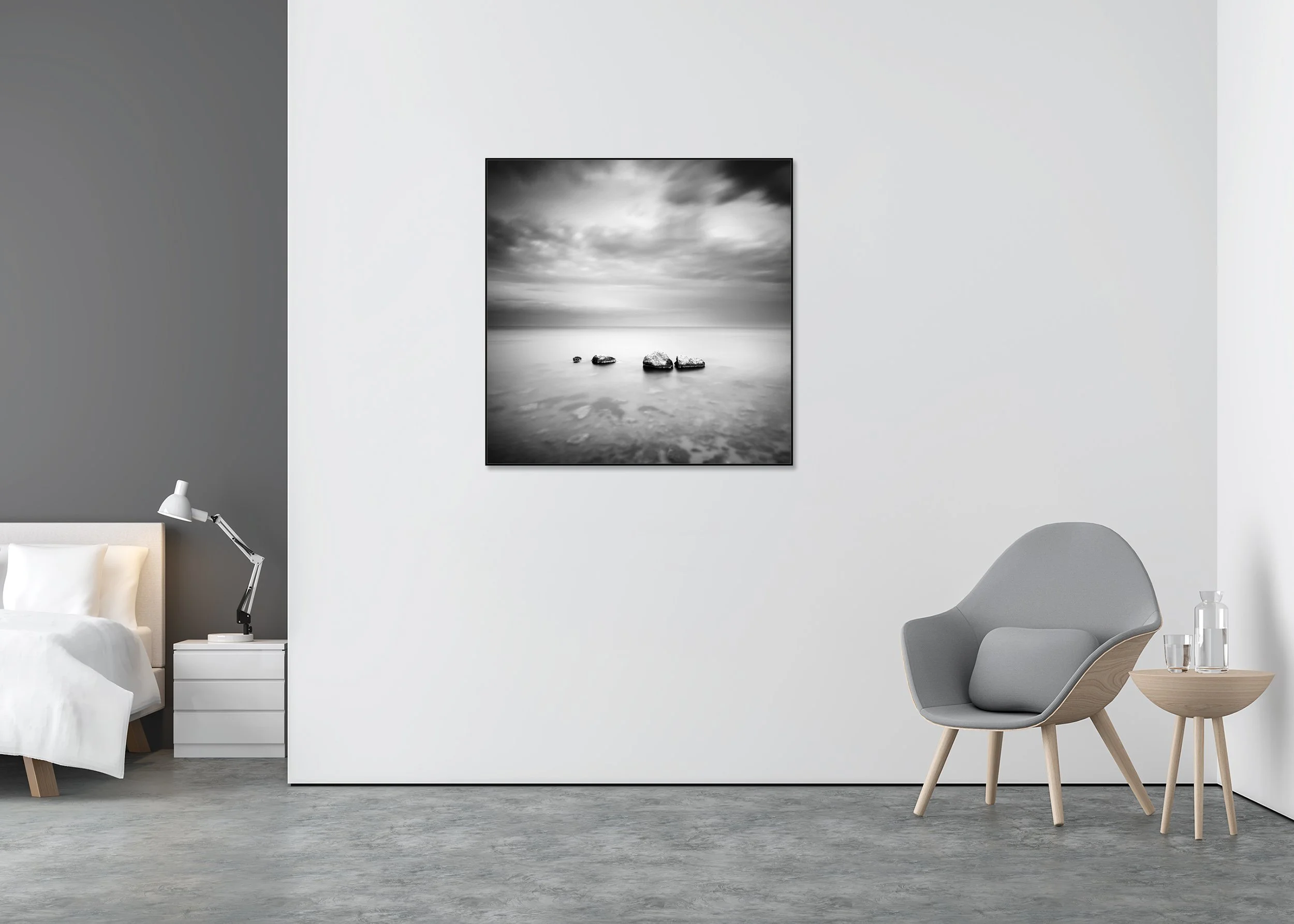 Black and white long-exposure seascape with four rocks in calm water beneath a cloudy sky on a ChromaLuxe metal print in an aluminium ArtBox.