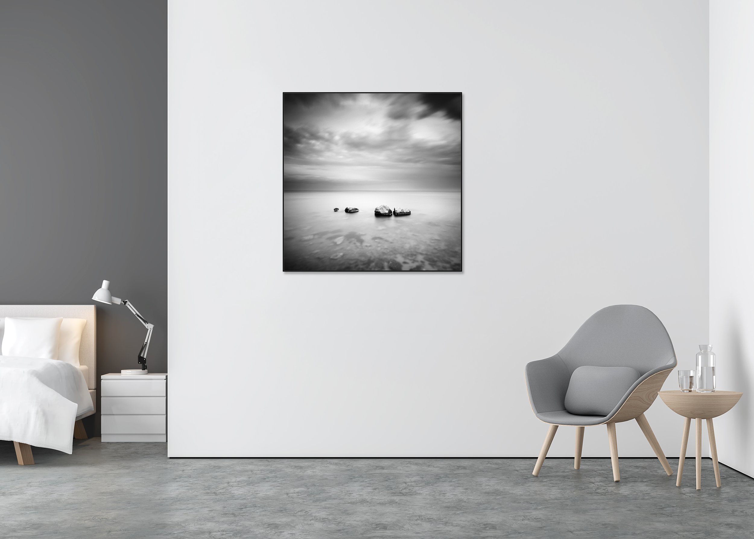 Black-and-white long-exposure seascape print with four rocks in calm water under a cloudy sky, mounted to Dibond in an aluminium ArtBox.