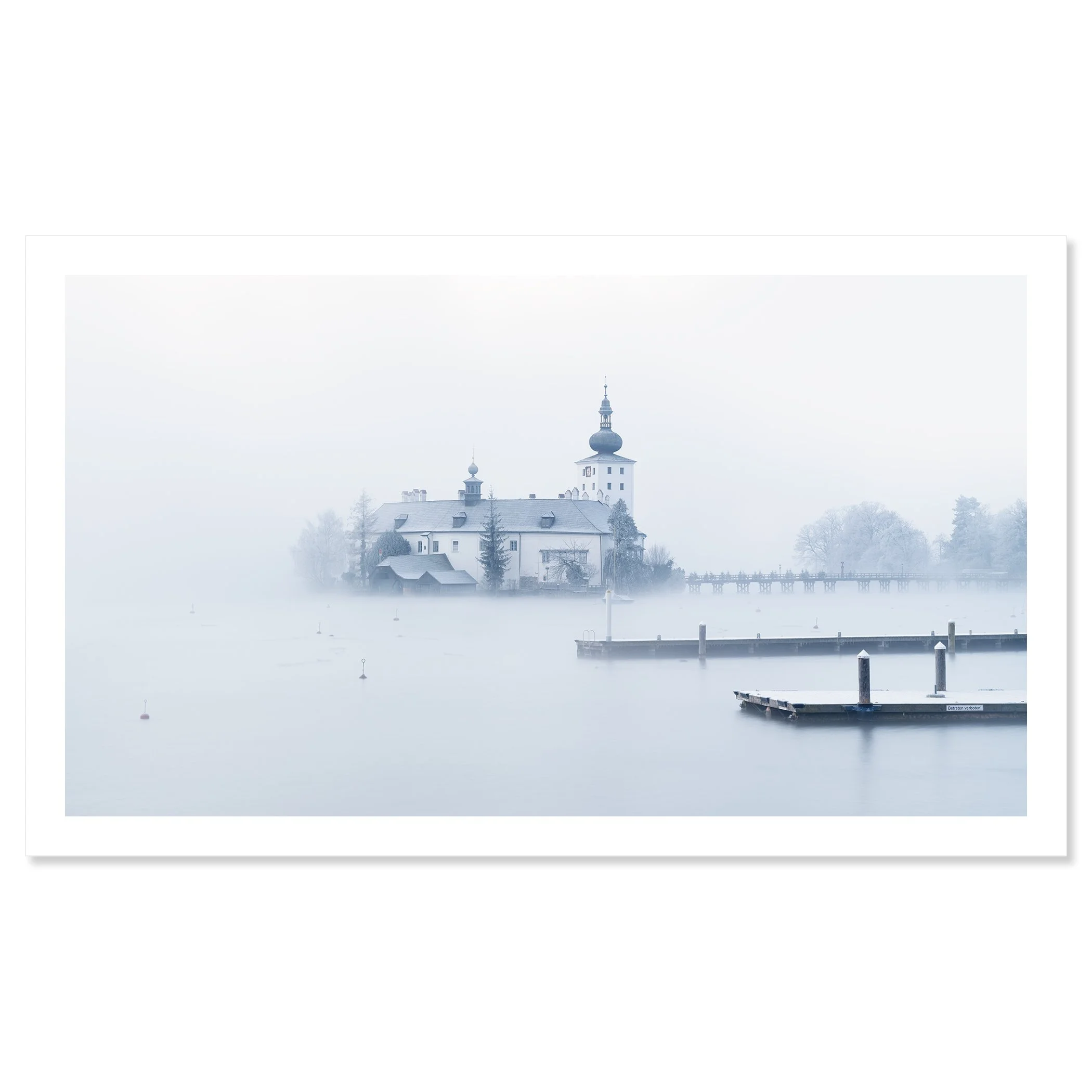 Gerald Bergammer - Color waterscape photography. A foggy lakeside scene with the historic lake castle ort and a dock, surrounded by leafless trees in winter. Fine art print only