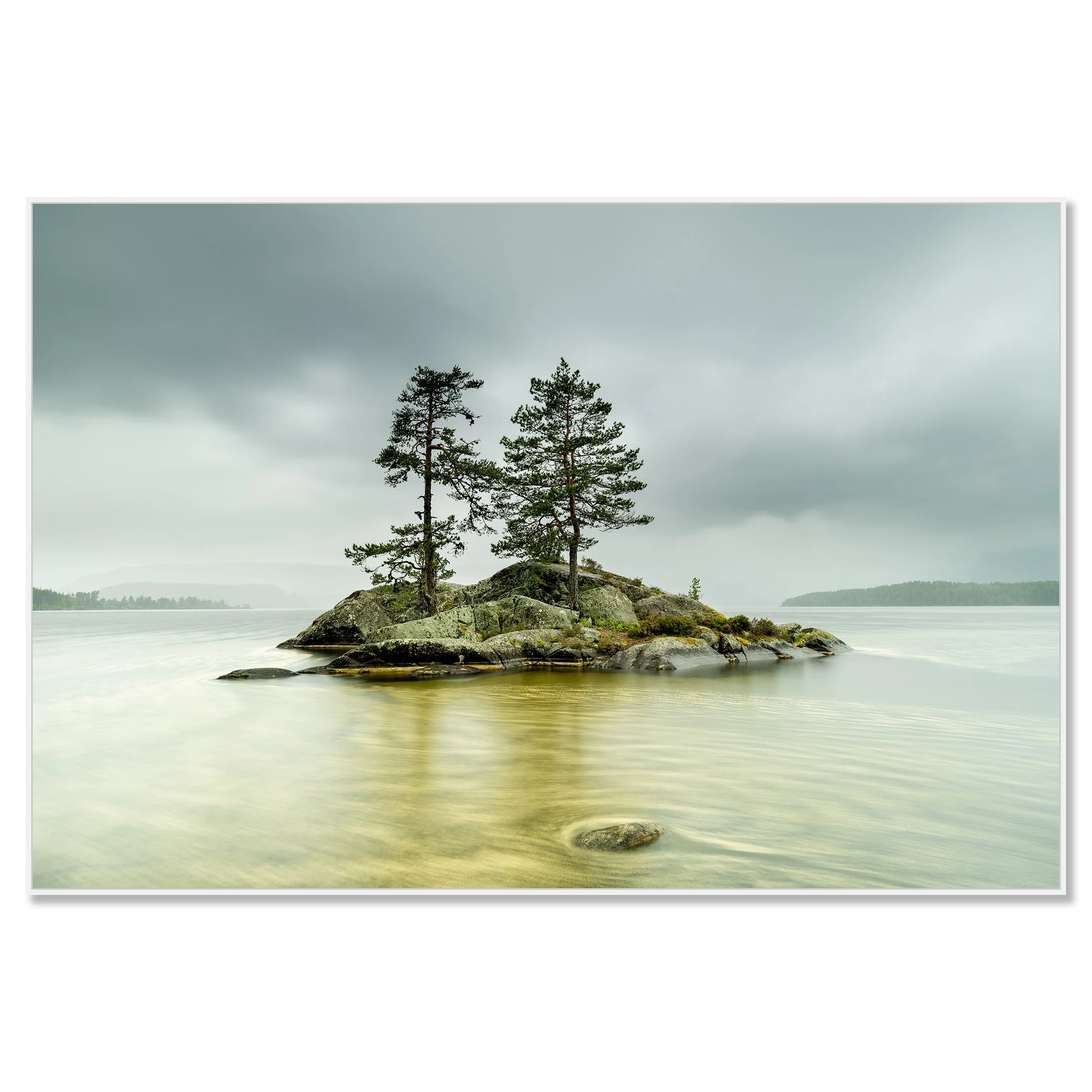 Two pine trees on a rocky island in a calm Norwegian lake under a cloudy sky – framed ArtBox white