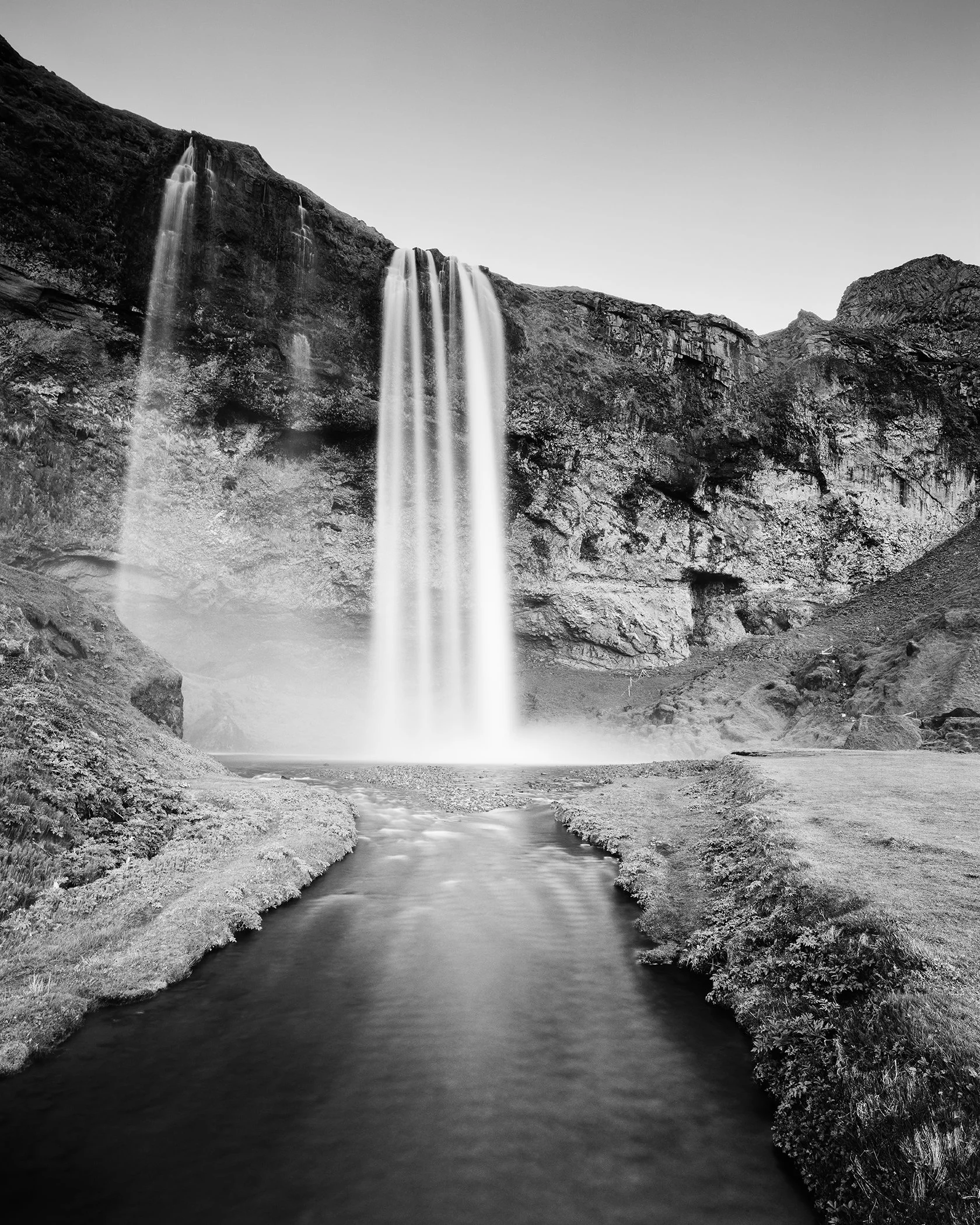 Seljalandsfoss Study 1 by Gerald Berghammer, black-and-white long-exposure photograph of Seljalandsfoss waterfall and river in Iceland.