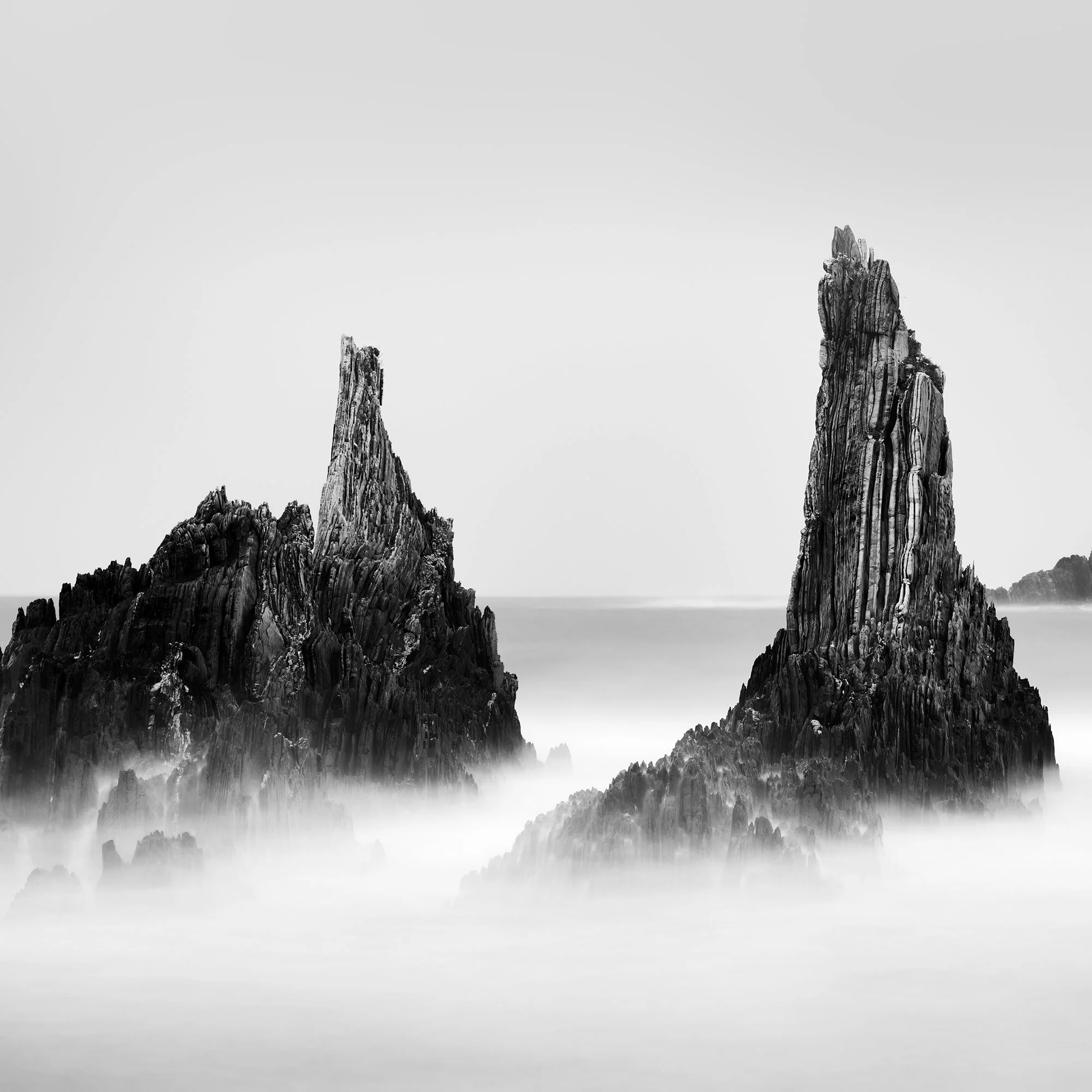 Detail of Rocky Peaks Panorama Study 5 by Gerald Berghammer showing jagged Atlantic rock formations emerging from mist-softened water in Spain.