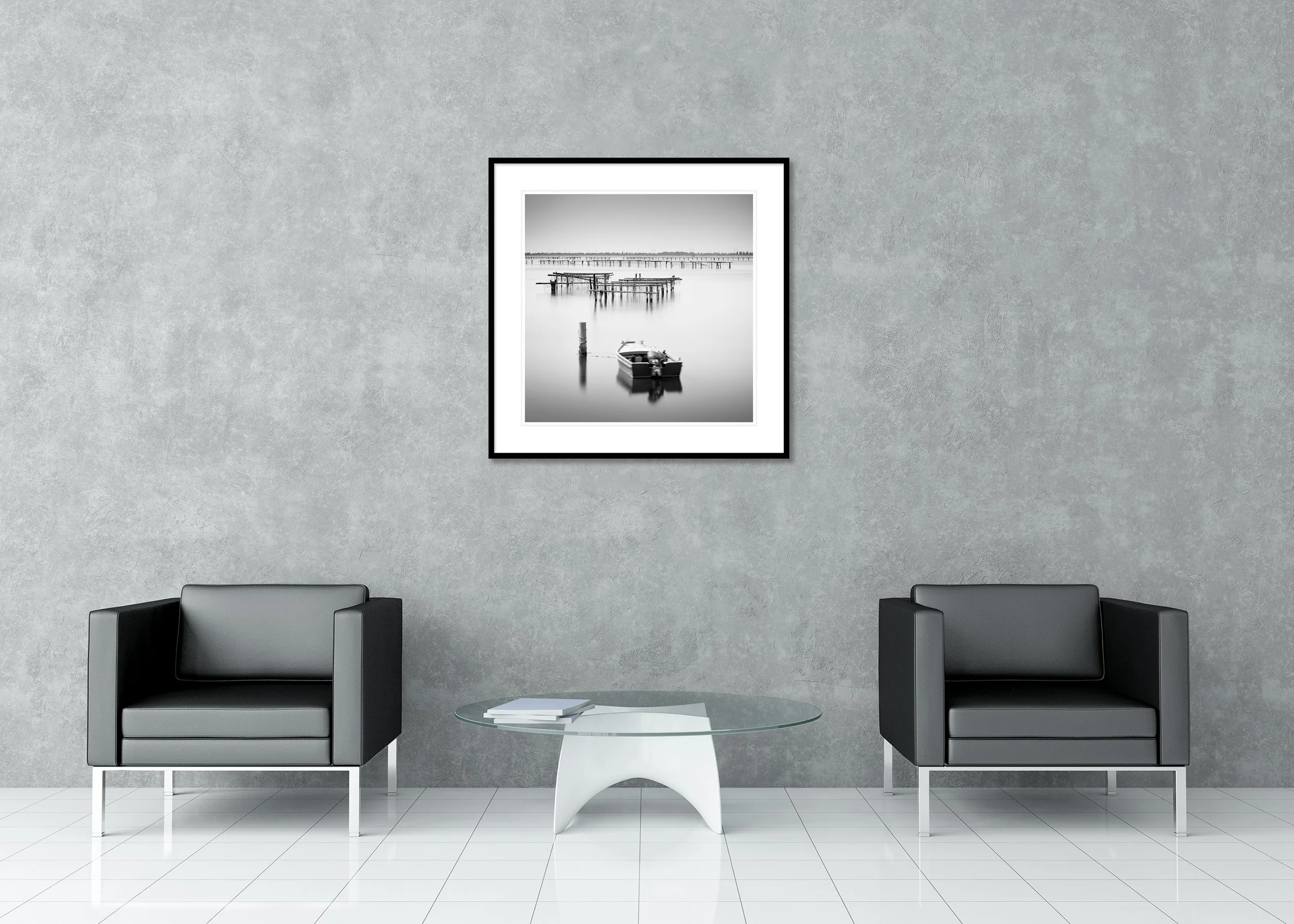Small boat moored on calm water, Italy — B&W seascape with wooden aquaculture piers, archival pigment print in a classic frame with passe-partout.