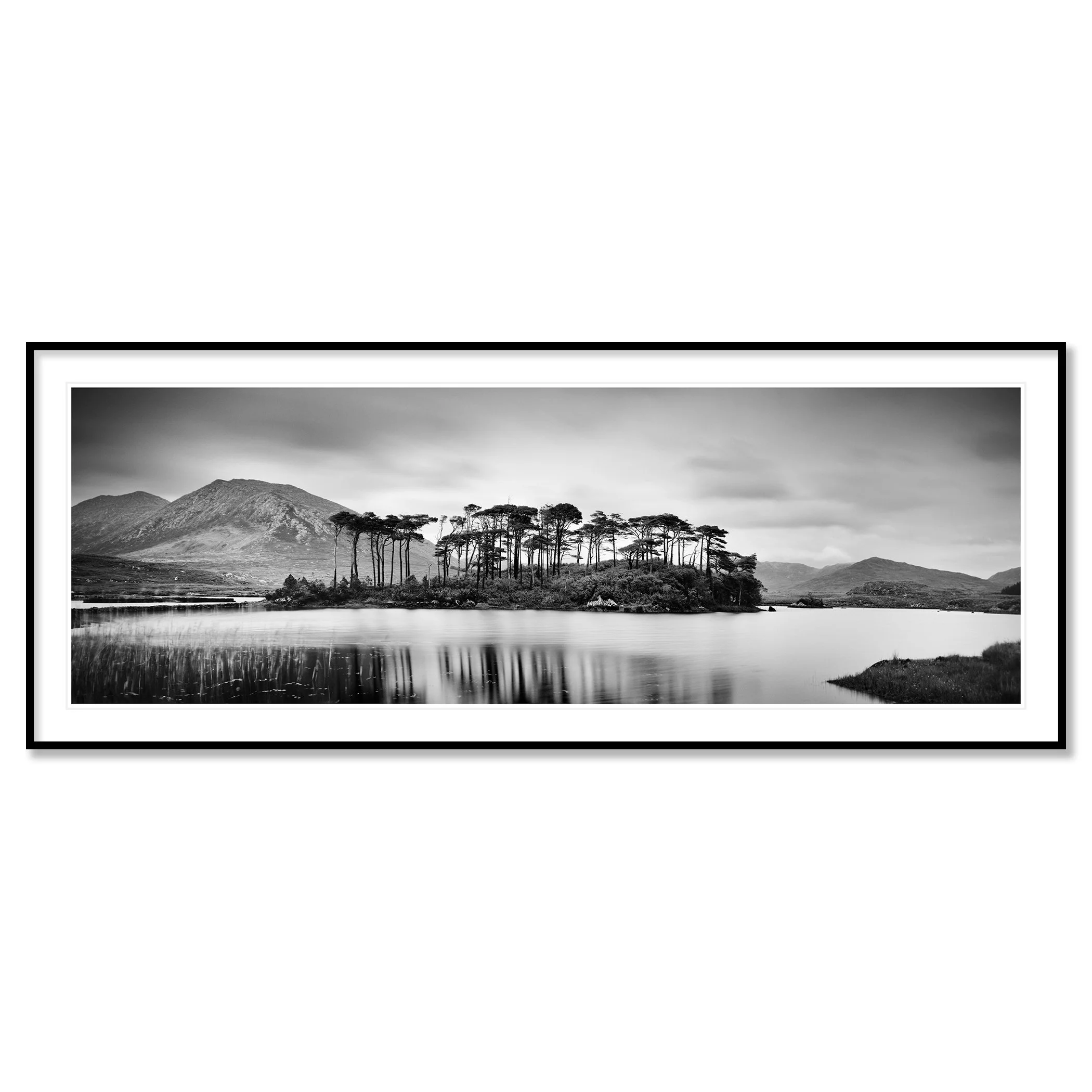 Gerald Berghammer - Black and white panorama landscape photography. Small island with tall trees, surrounded by water, mountains, and cloudy sky. Classic framed black