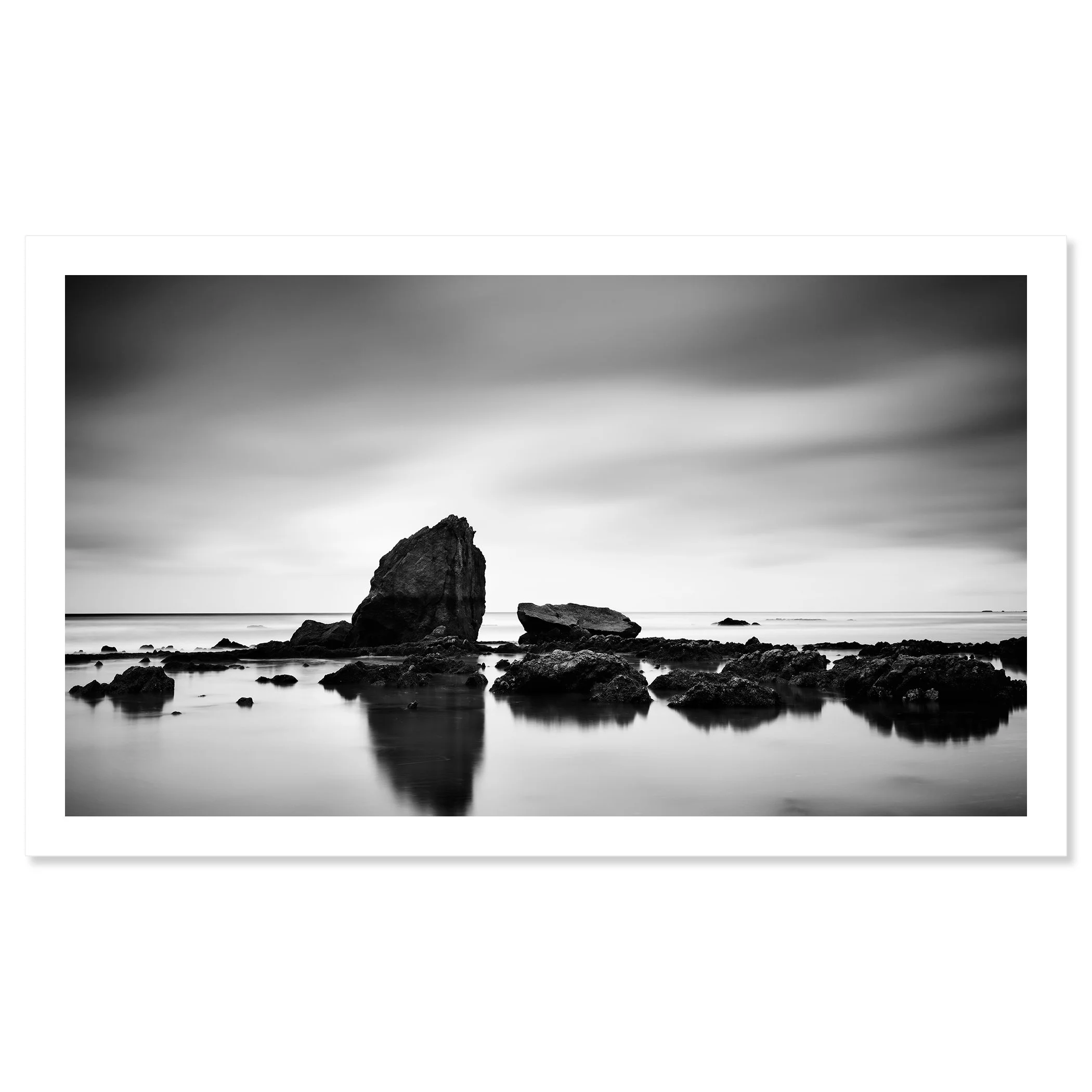 © 2023 Gerald Berghammer - Black and white minimalist beach seascape. A rocky shoreline with a large prominent rock formation in the water. Fine art print only