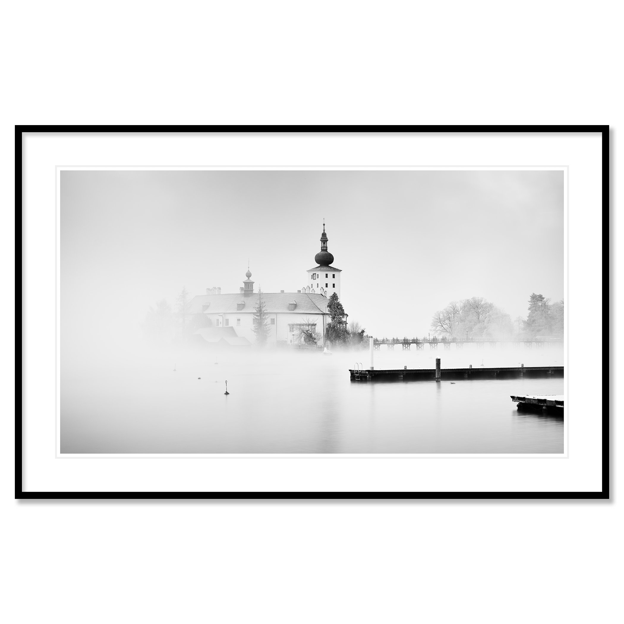 © 2022 Gerald Berghammer - Black and white cityscape photography. Schloss Ort - The historic church surrounded by mist over a lake with docks in the foreground. Classic framed black