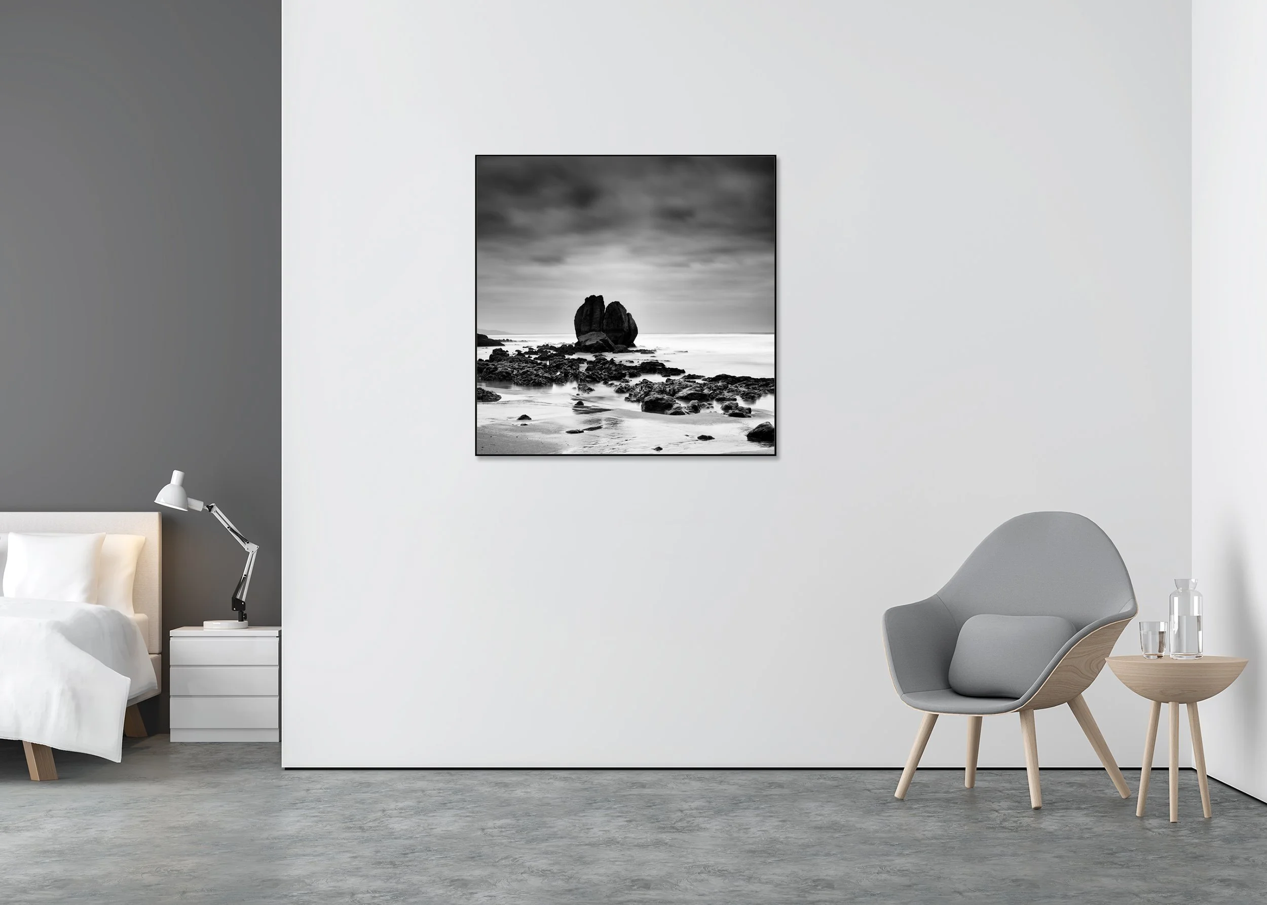 Long exposure black and white coastal photograph with rocky shore and moody clouds, mounted on Dibond in an aluminium ArtBox frame