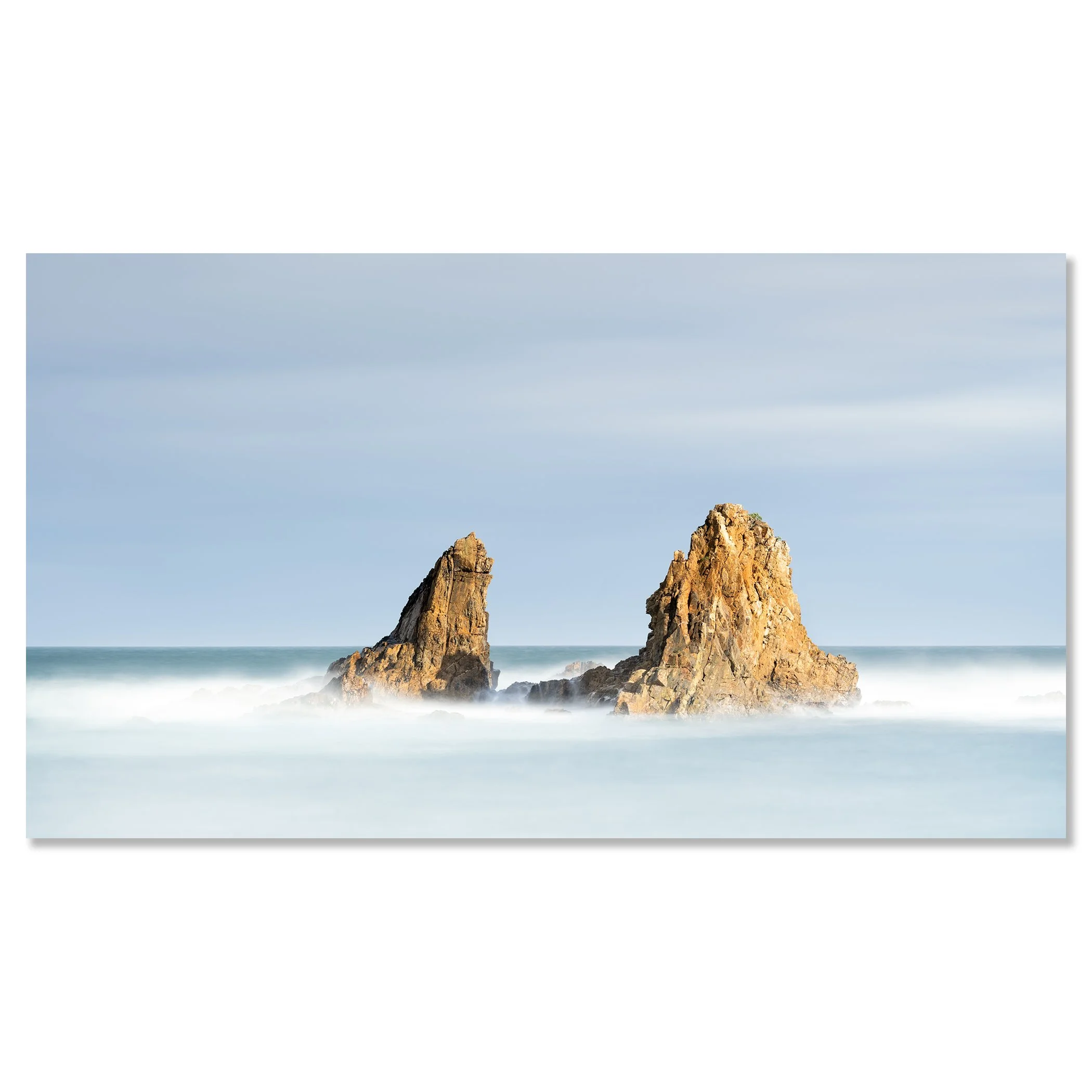 Gerald Berghammer - Color Seascape Photography. Two large rocks rising out of the ocean with waves crashing around them under a blue sky. Chromaluxe frameless