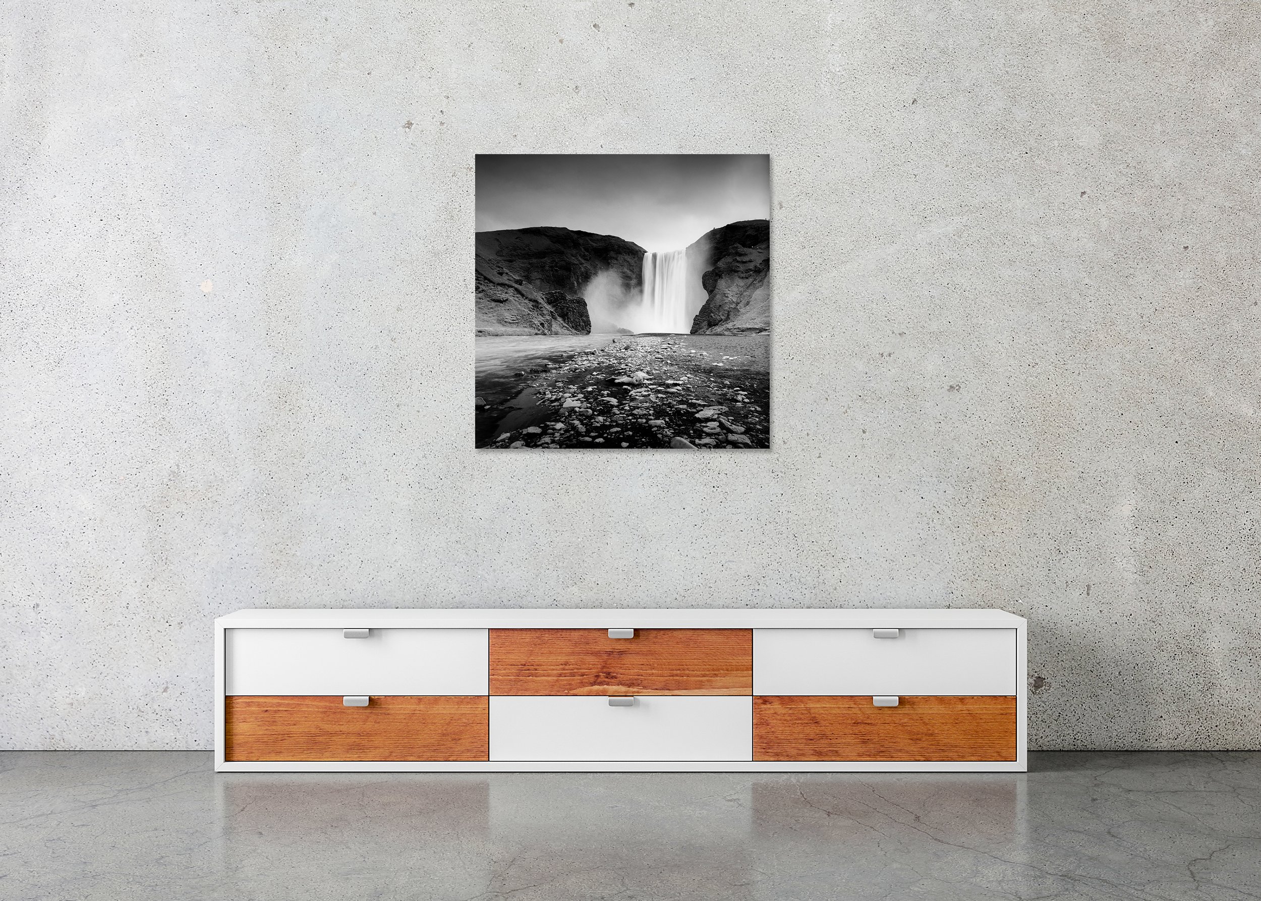 Skogafoss Waterfall Study 3 – Iceland, frameless black-and-white photograph on aluminium Dibond displayed in a minimalist interior. Photo by Gerald Berghammer.