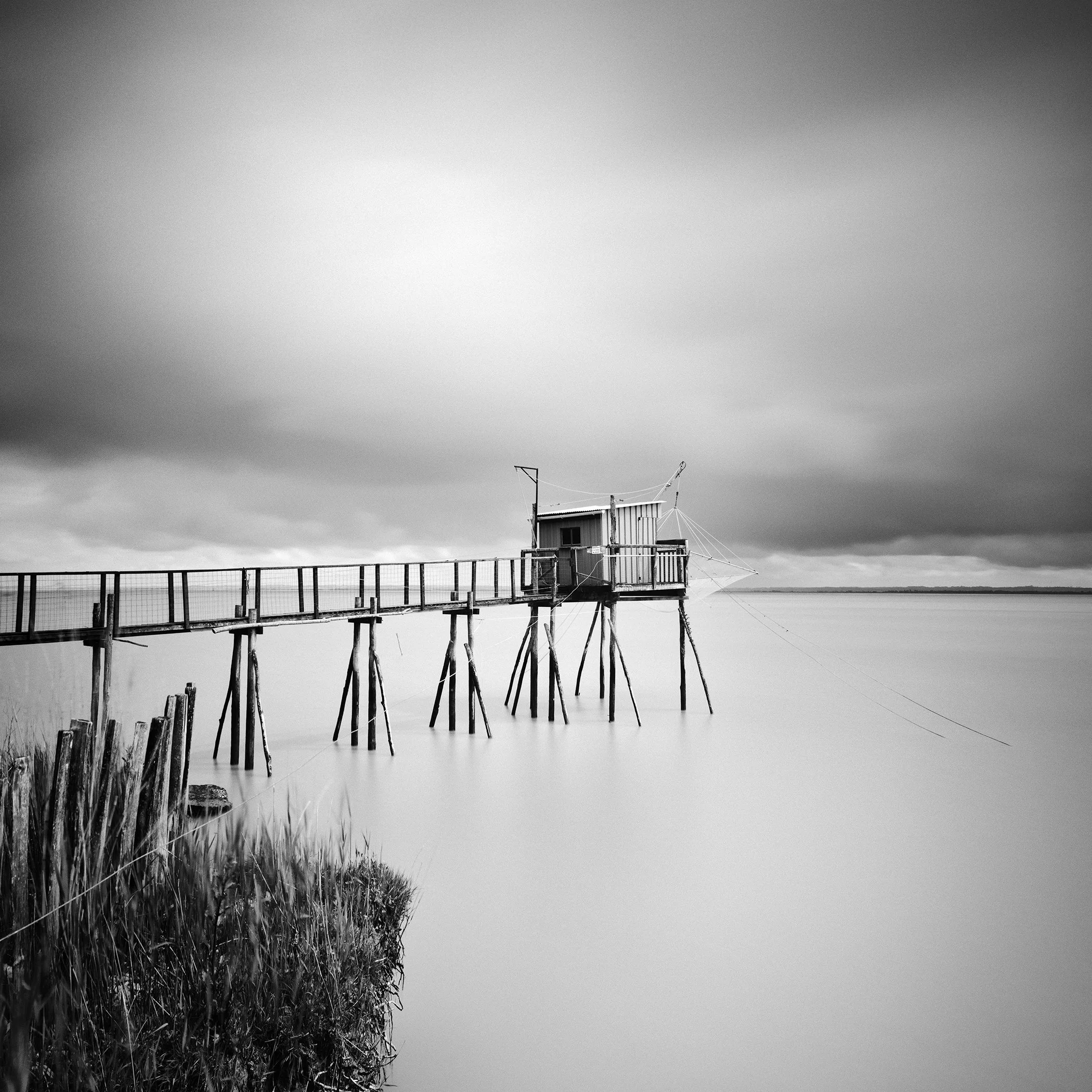 Stilt House PK 53880 by Gerald Berghammer, analogue black-and-white long-exposure fine art photograph of a fishing hut on stilts on the French Atlantic coast.