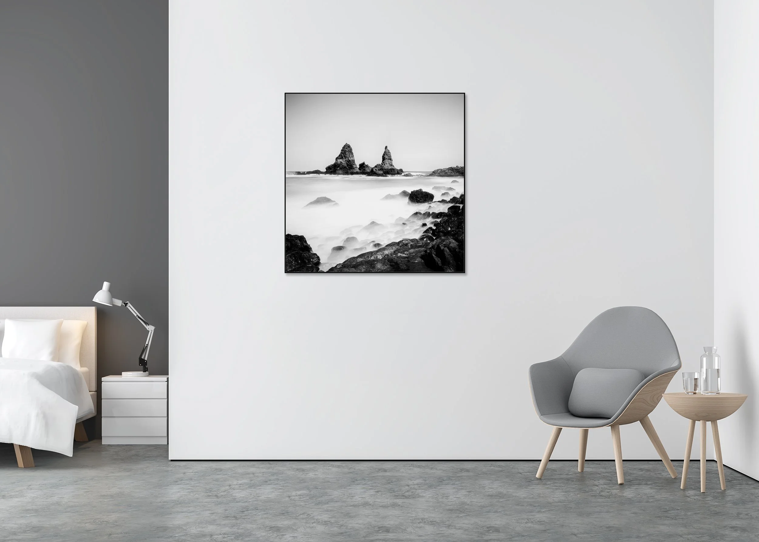 Black-and-white seascape print with jagged sea stacks and misty surf, mounted to Dibond in an aluminium ArtBox