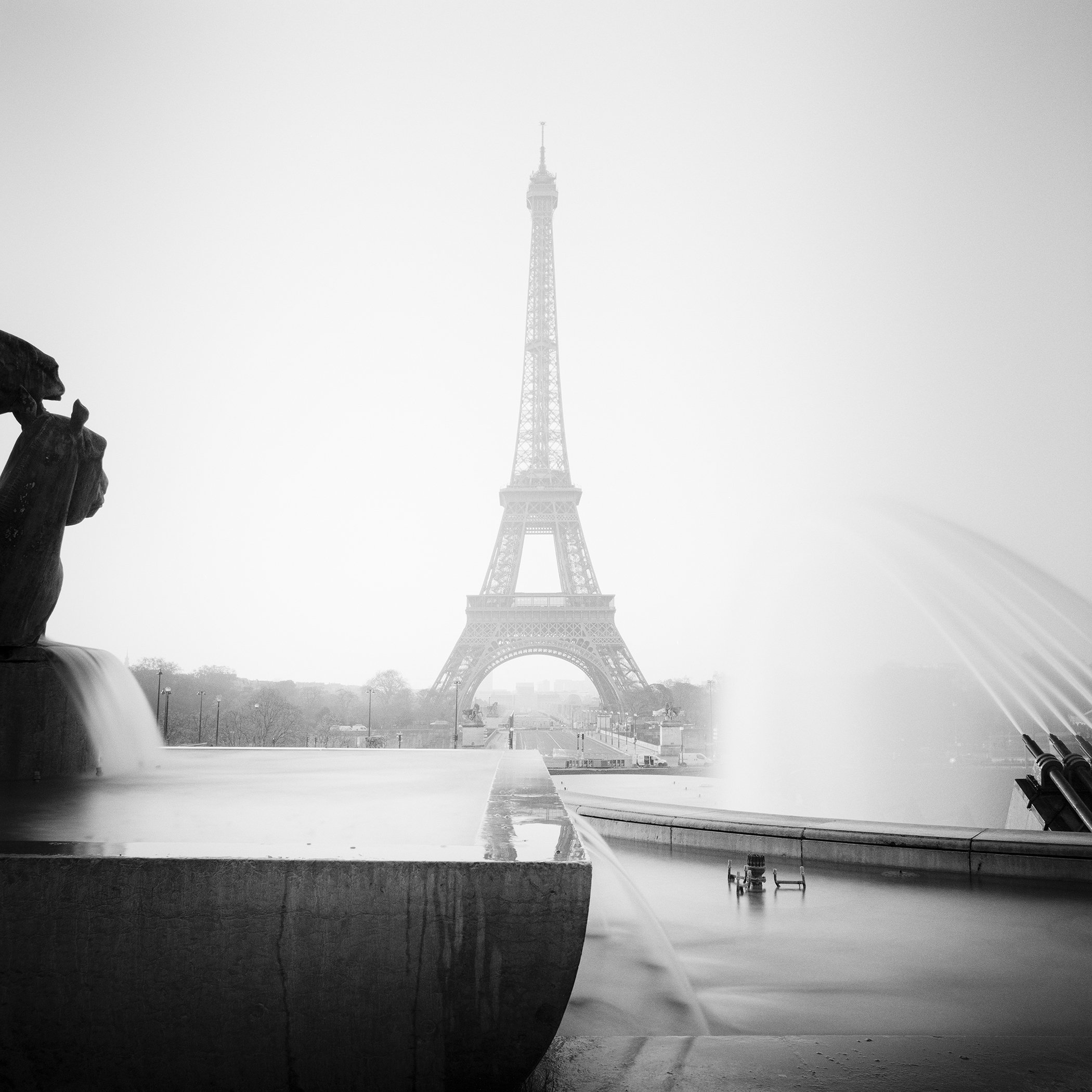 Black-and-white fine art photograph of the Eiffel Tower in Trocadéro fountain mist by Gerald Berghammer