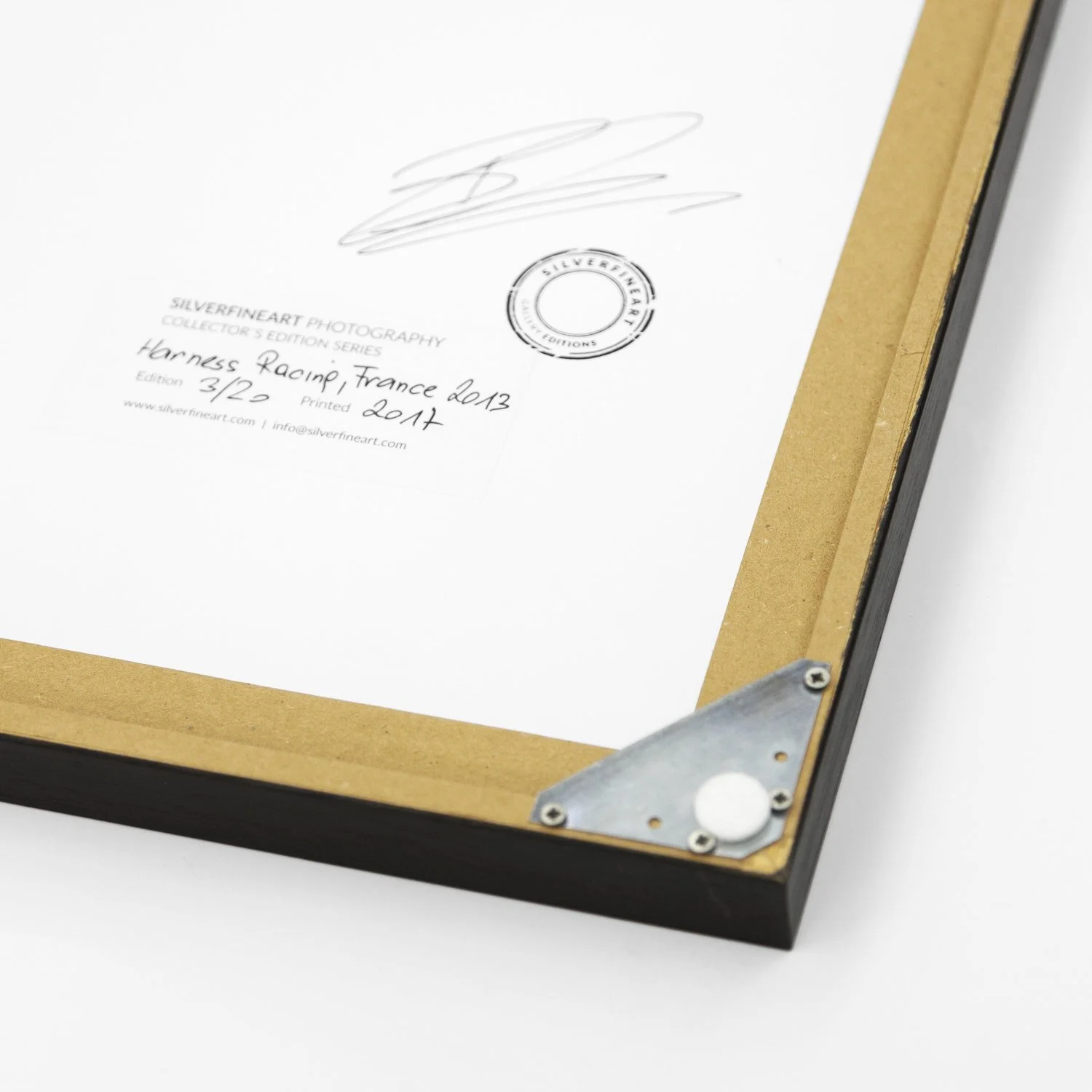 Reverse detail of Harness Racing – France by Gerald Berghammer, showing the artist's signature, gallery stamp and wooden frame construction.