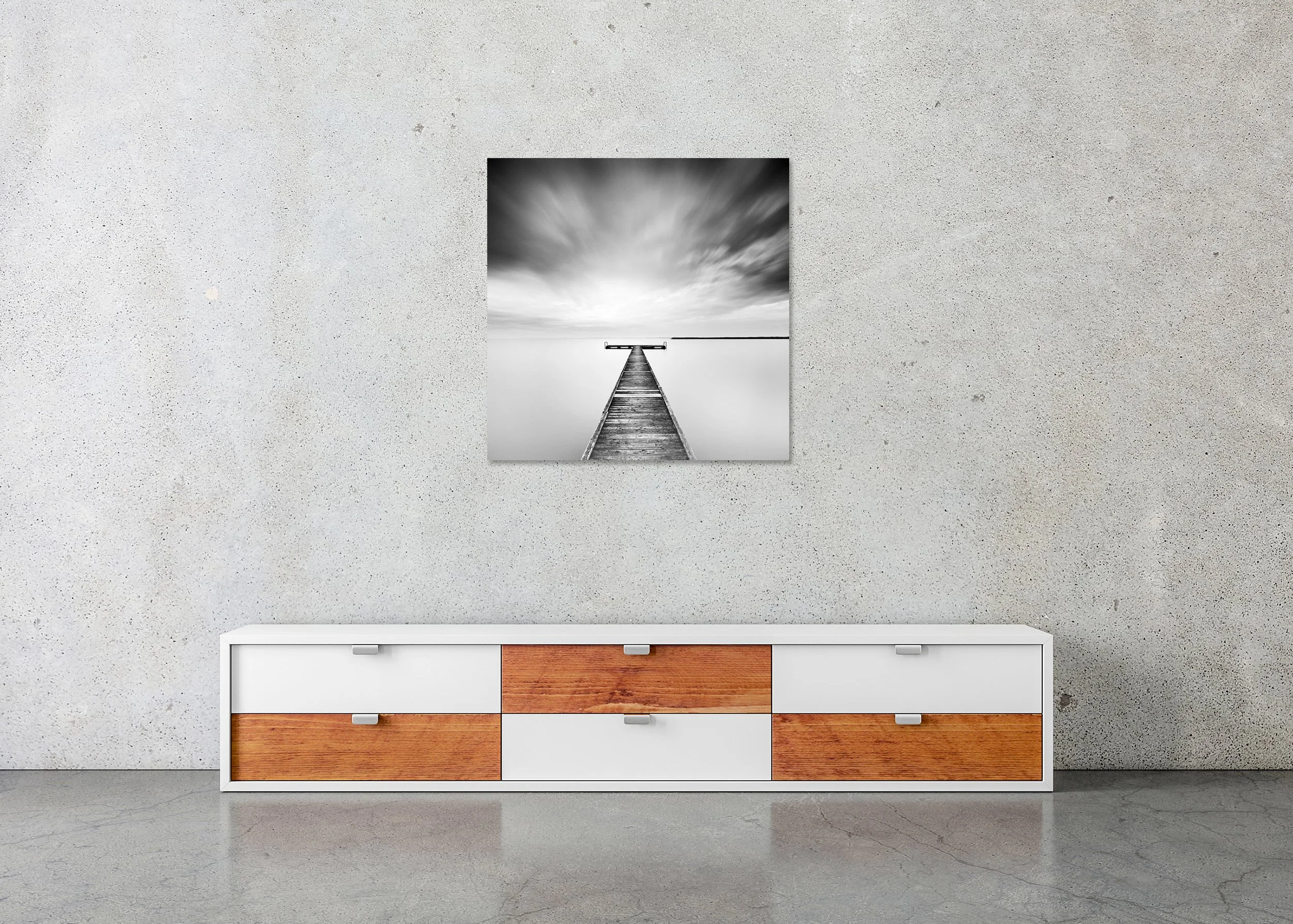Monochrome long exposure photo of a wooden pier on a still lake beneath a moody sky, photo print mounted to Dibond, frameless