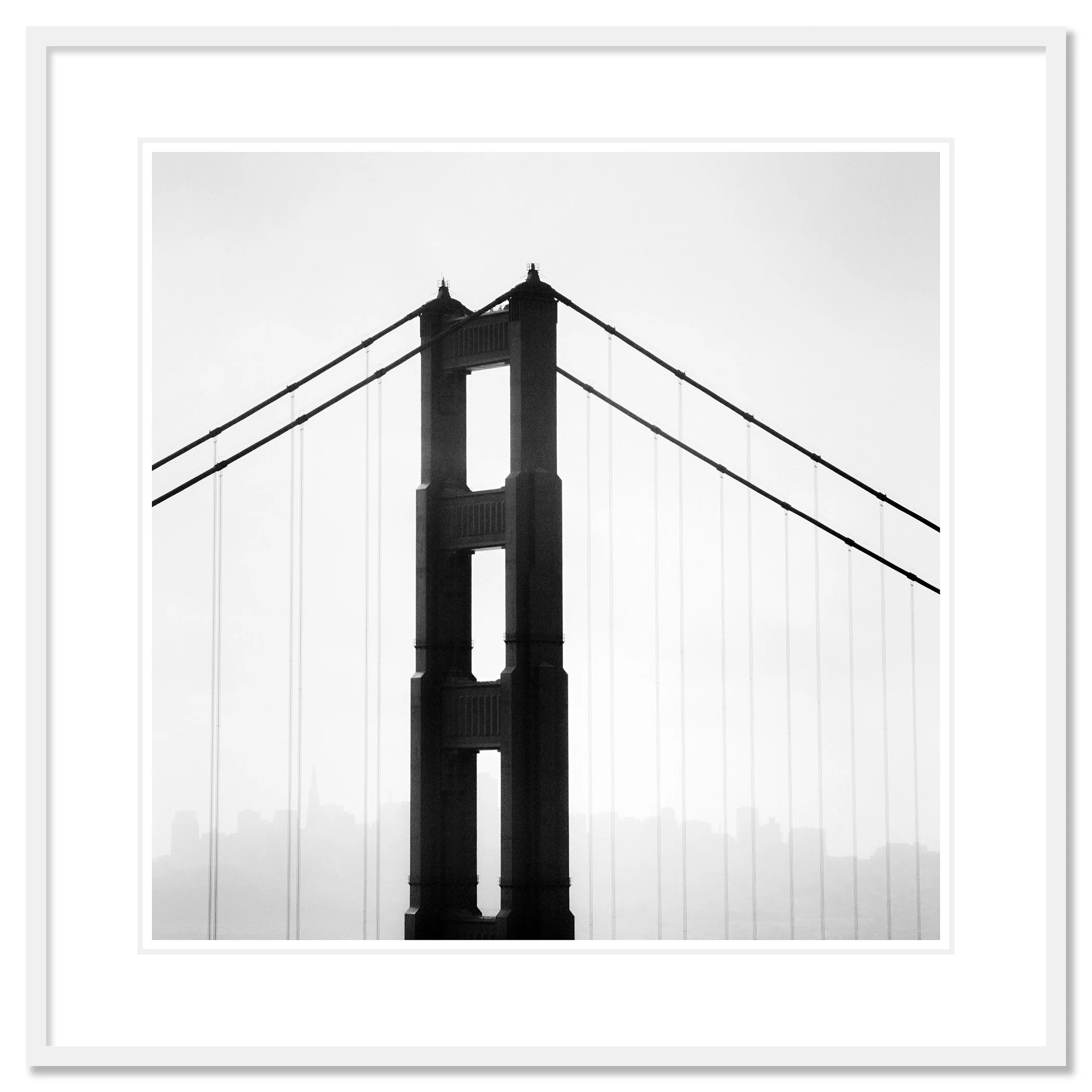 © 2015 Gerald Berghammer - Black and white photo. Golden Gate Bridge in San Francisco, seen from the side, with the city skyline faintly visible in the background. Classic framed white