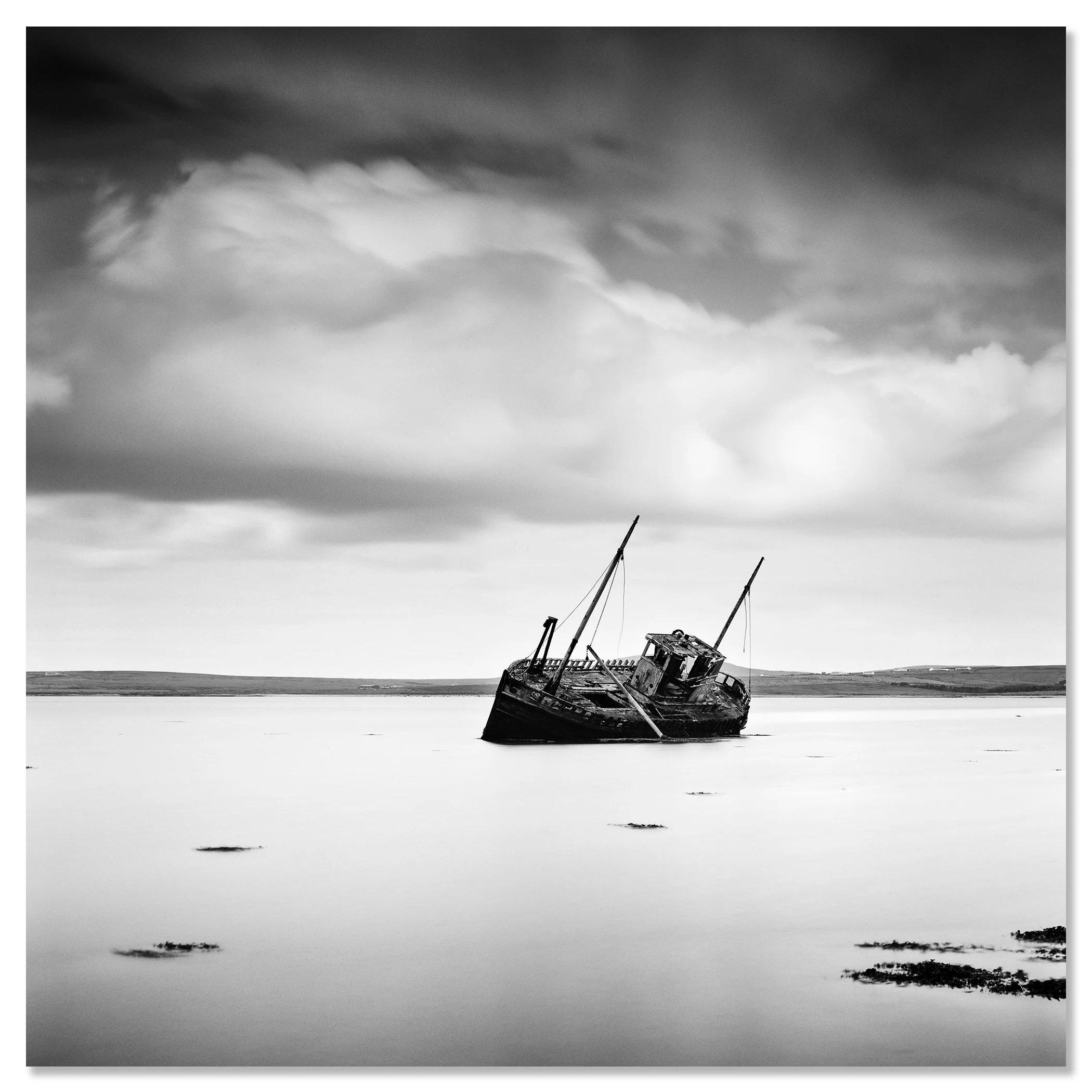© 2014 Gerald Berghammer - Black and white minimalist seascape photography. An abandoned boat stuck in shallow water with cloudy sky overhead. Chromaluxe frameless