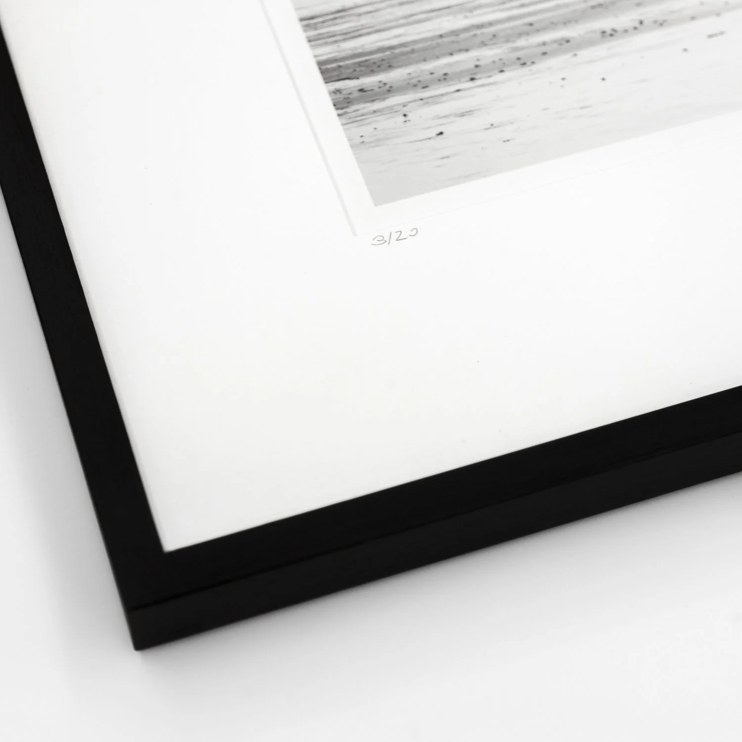 Detail of the black wooden frame, archival mount and handwritten edition marking of Harness Racing – France by Gerald Berghammer.