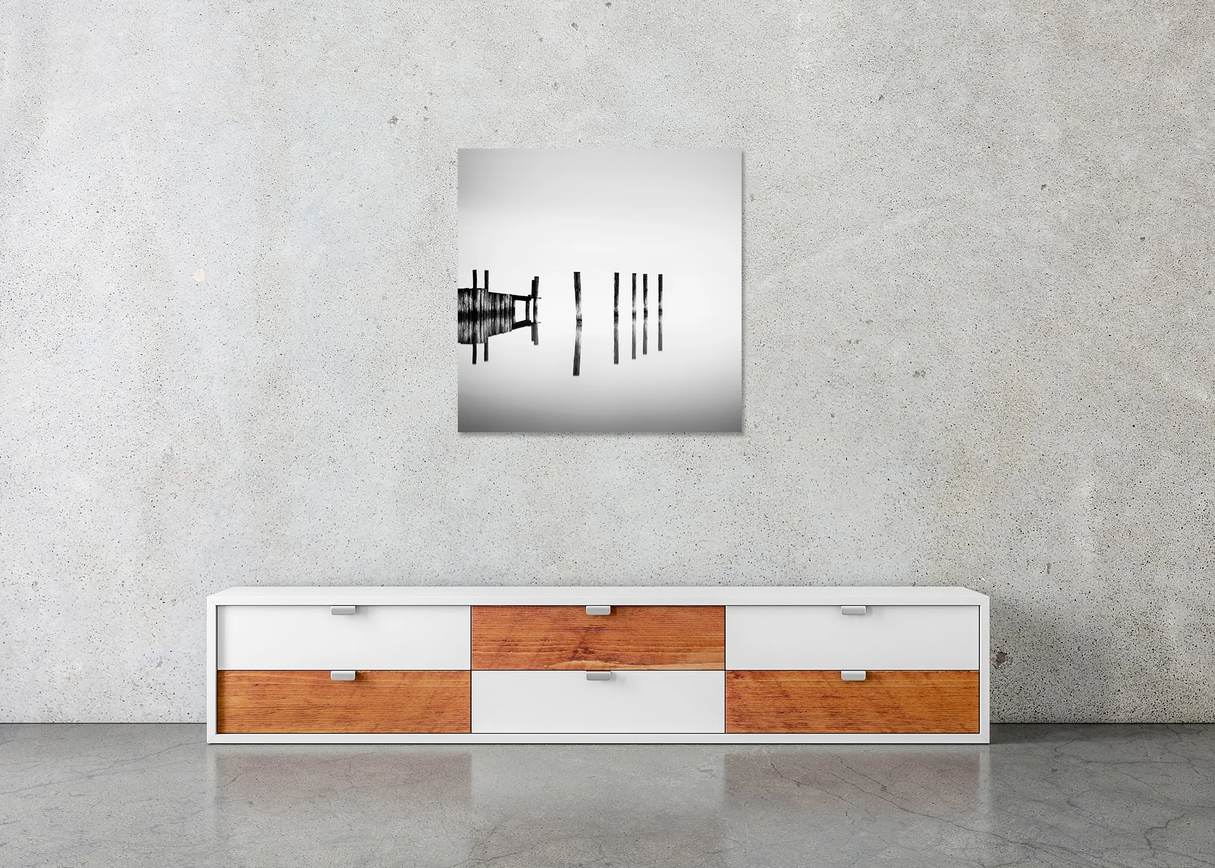 Abstract black and white photograph of wooden pier posts reflected in calm water. ChromaLuxe Metal Print – Frameless