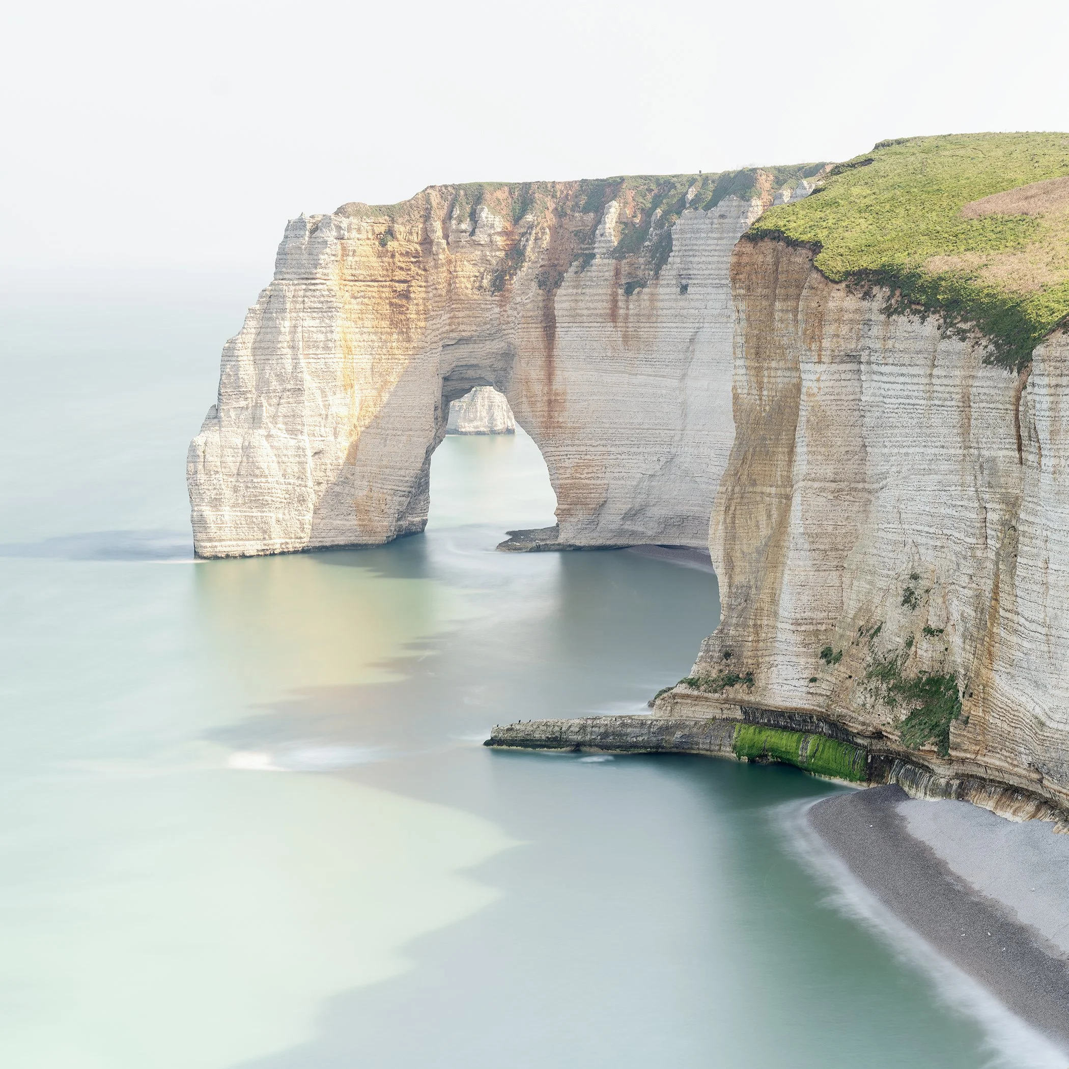 Long-exposure colour photograph of Étretat’s chalk cliffs and sea arch on the Alabaster Coast, France, by Gerald Berghammer.