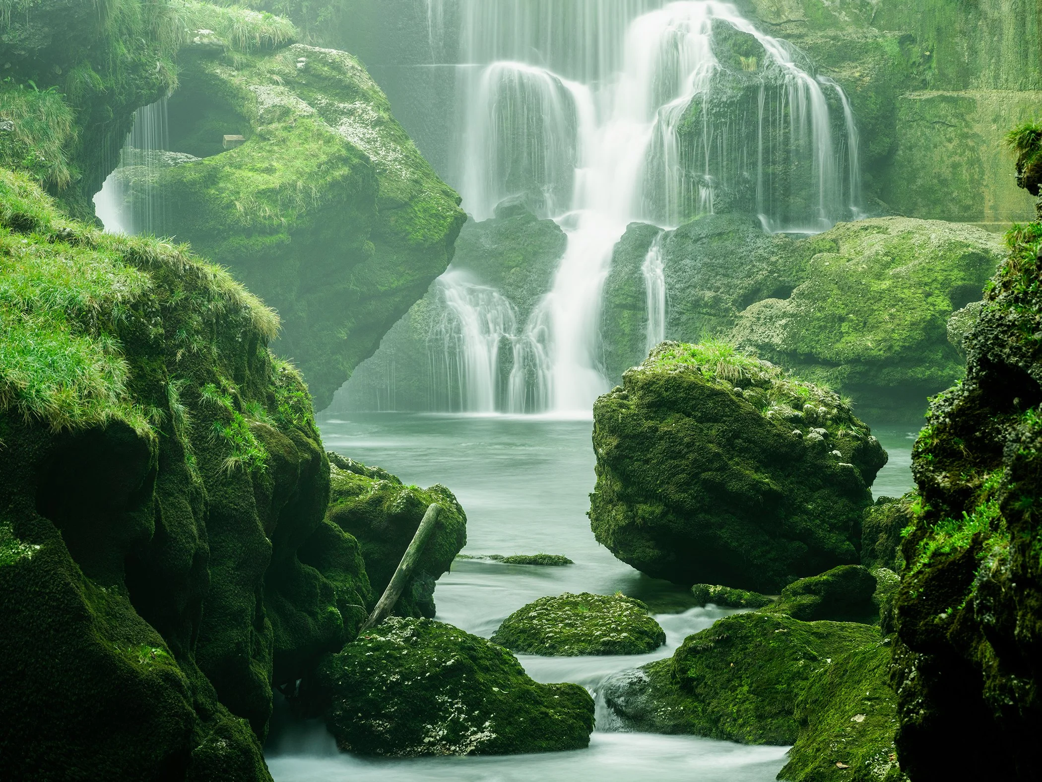 Moss-Covered Waterfall Study 1, colour fine art photograph of cascading water and moss-covered rocks in Austria by Gerald Berghammer.