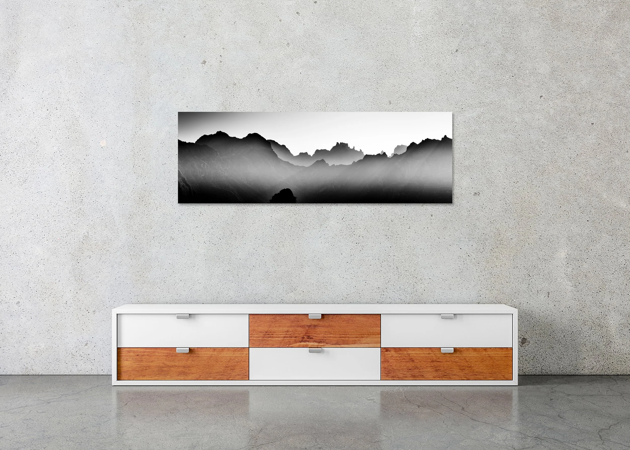 Mountains in Shadow with Morning Light displayed in a modern interior as a frameless black-and-white artwork mounted on aluminium Dibond by Gerald Berghammer.